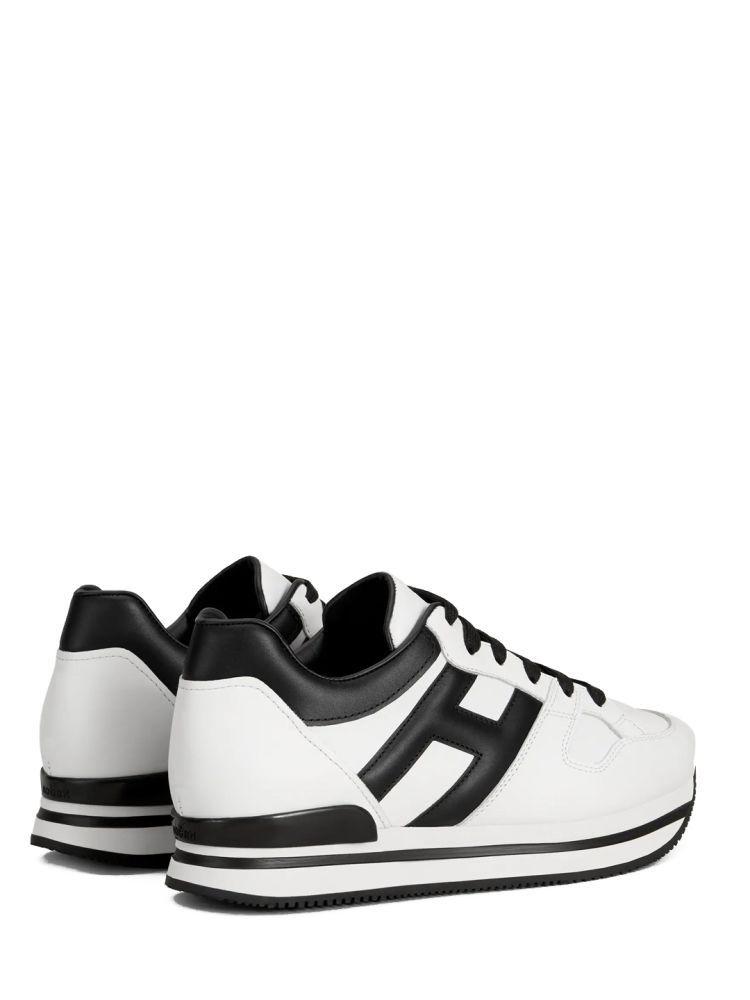 H222 sneakers in white leather with contrasting black inserts. They feature padded side H, removable footbed with 6,7 mm rise and ultralight EVA sole.Total height: 5cm