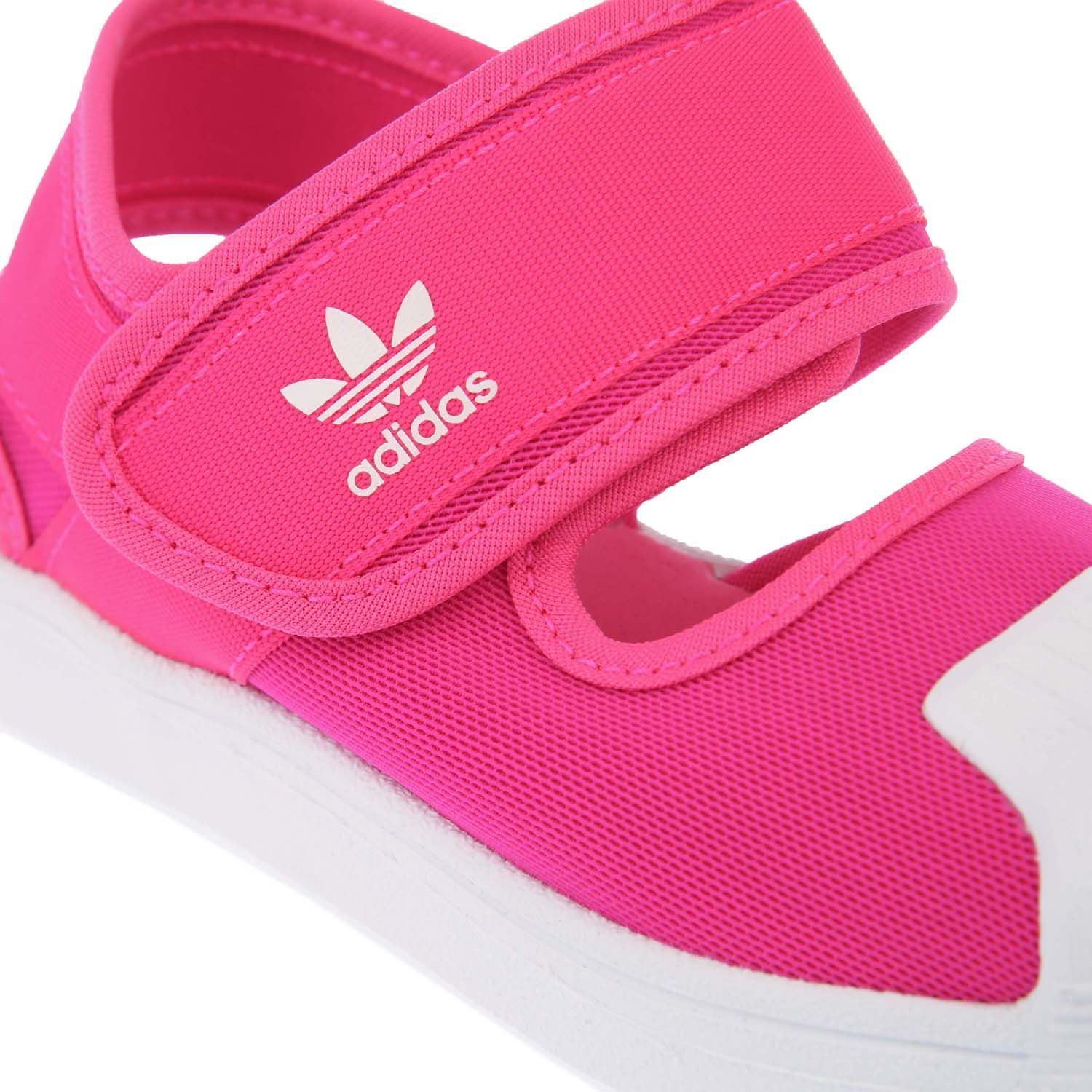 Childrens adidas Originals Superstar 360 Sandals in pink white.- Open mesh upper.- Hook-and-loop strap closure.- Adjustable strap.- Lightly cushioned footbed.- EVA outsole.- Rubber sole and shell toe.- Textile and Synthetic upper  Textile lining  Synthetic sole.- Ref.: FV7585C