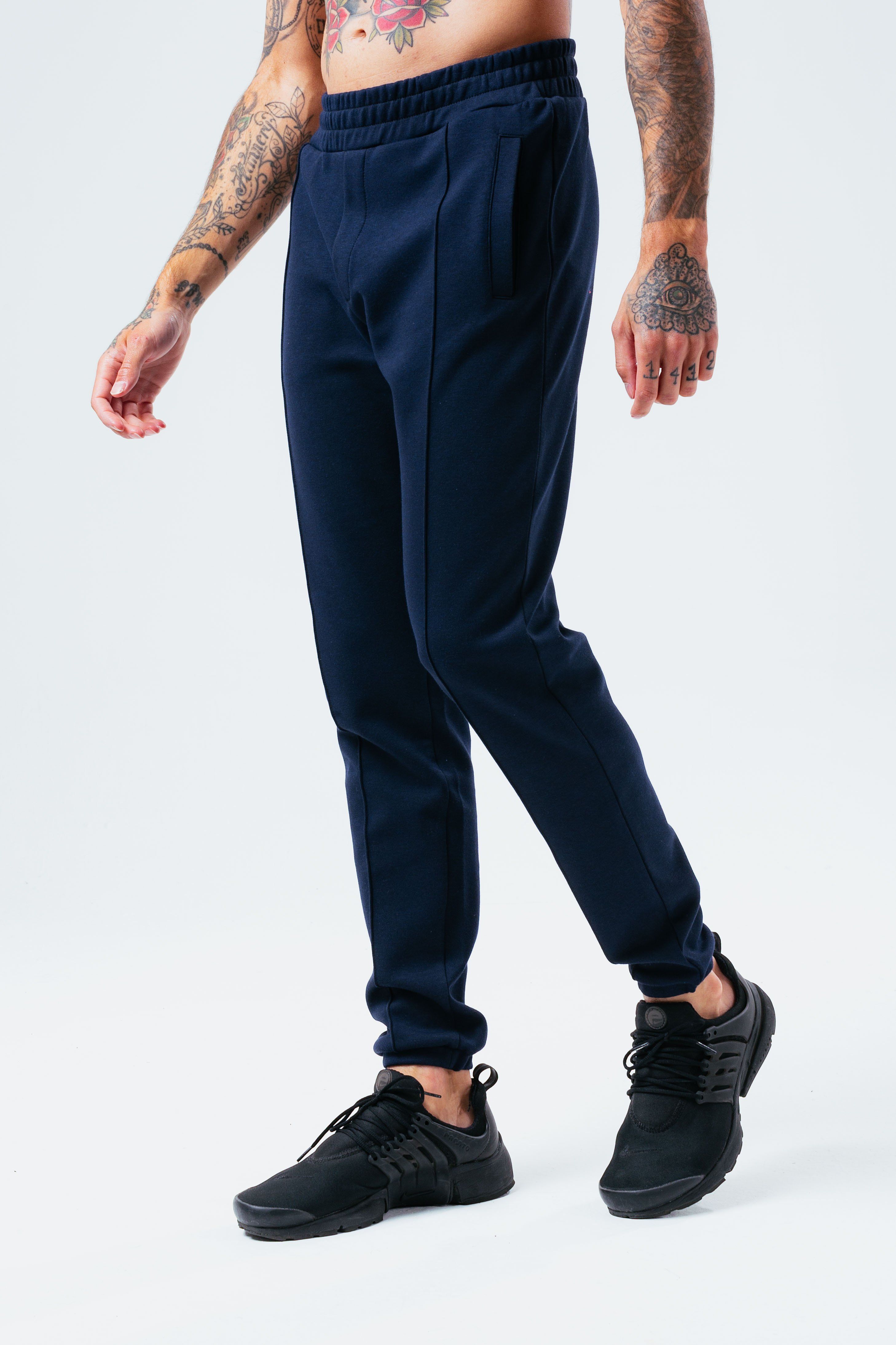 The HYPE. Epworth Joggers are your go-to summer staple. Designed in a 80% cotton and 20% polyester fabric base for the ultimate comfort. With drawstring pullers and an elasticated waistband. Finished with a stitched pleat detailing in a royal navy colour palette. Wear with the matching hoodie to complete the look. Machine washable.