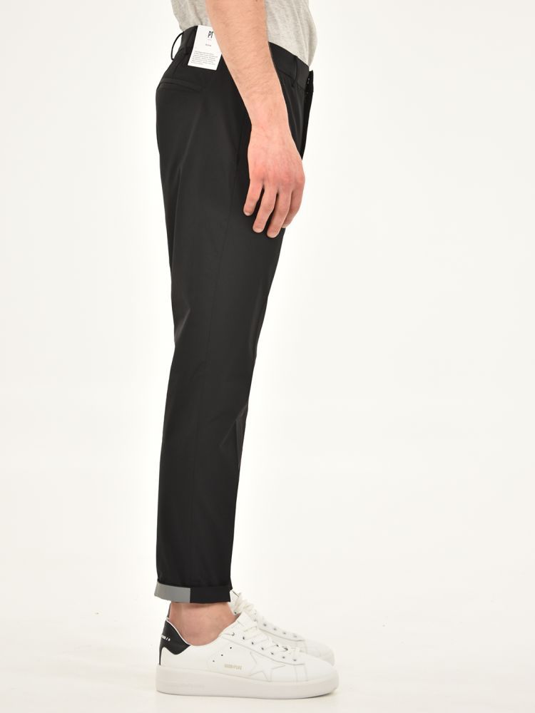 Black stretch fit nylon trousers with turn-up at the bottom. Side and back pockets, belt loops at the waist.The model is 183 cm tall and wears size M