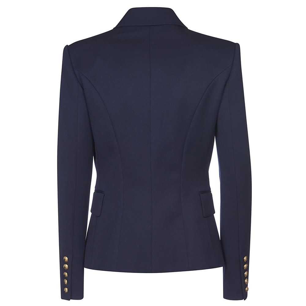 Double breast wool blazer with a gold button closure, classic lapels, long sleeves, padded shoulders and front pockets.