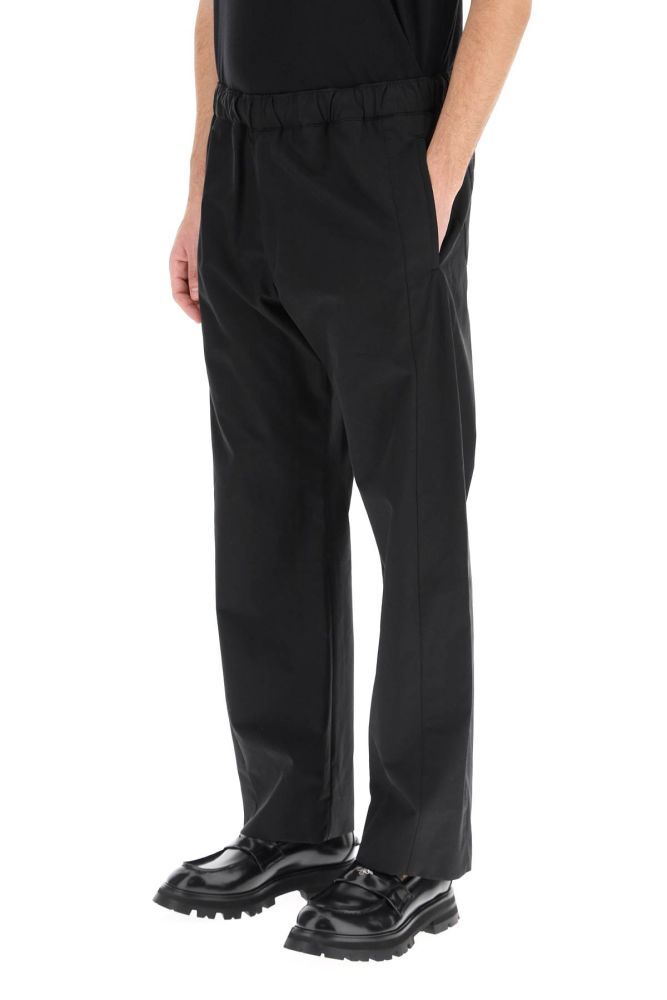 Alexander McQueen informal trousers cut from lightweight cotton gabardine to a loose fit. It features an elasticated waistband, piped side pockets, rear patch pockets with button, zip fly. The model is 186 cm tall and wears a size IT 48.