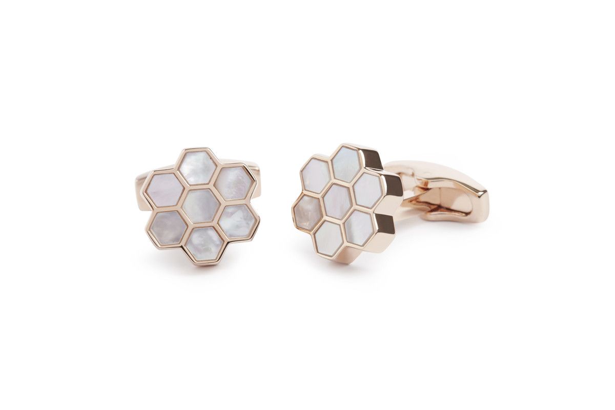 A rosegold plated honeycomb designed cufflink with white Mother of Pearl compartments.