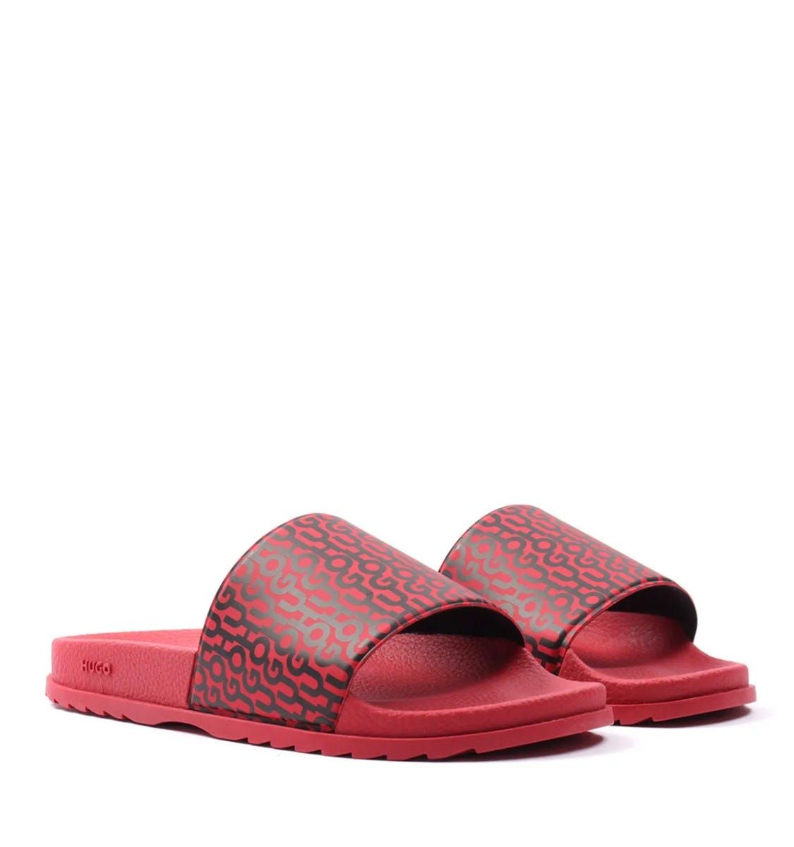Slide your feet into standout style with the Match Slides from HUGO. These lightweight quicky drying slides are ready to make a statement with the iconic HUGO logo repeat printed across the rubberised foot straps.  Perfect for the pool, beach, garden or even lounging around. Featuring an ergonomically designed footbed for optimum comfort and a non slip outsole. Synthetic Rubber Composition, Ergonomic Designed Footbed, Non Slip Outsole, Made in Italy, HUGO Branding.