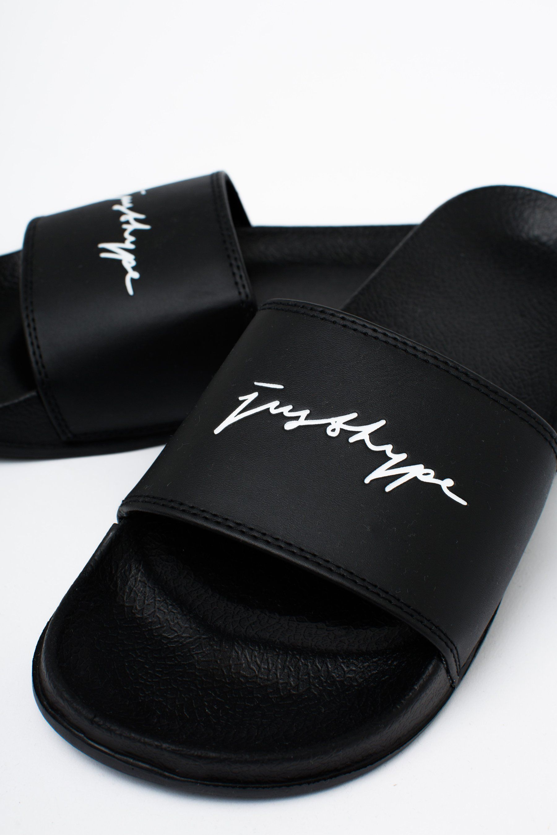The ultimate footwear to take your comfort level from 0 - 100. The HYPE. men's black signature sliders feature a black base on the sole and crest. Designed in the upmost supreme amount of comfort finished with the just hype signature logo in a contrasting white. Wear around the pool with swim shorts or with a tracksuit set and ribbed crew socks for an off-duty style. Wipe clean only.