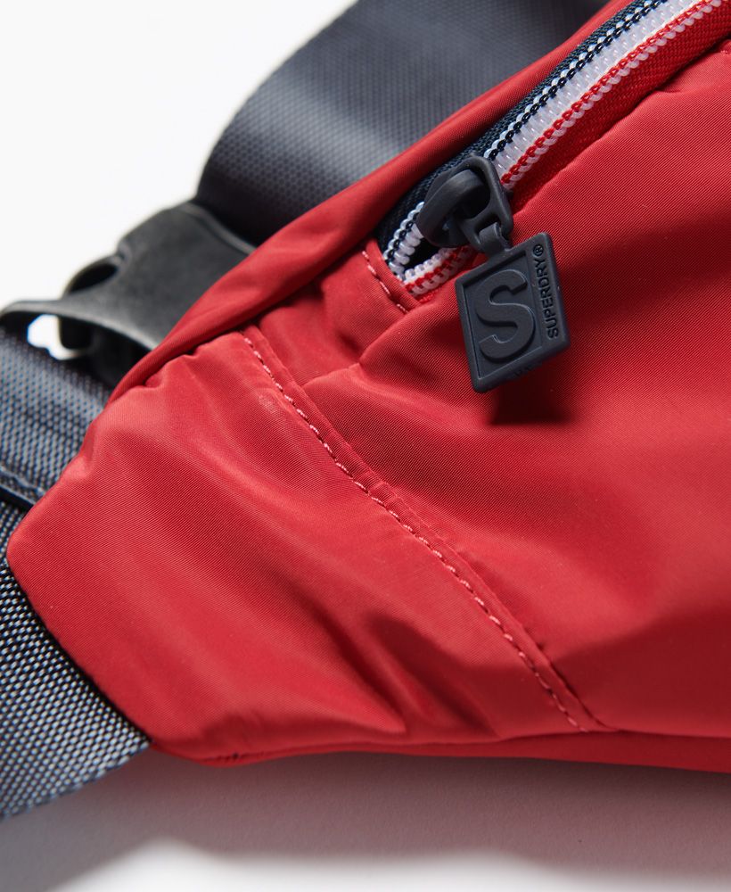 Keep your essentials close this season with the Sportstyle bum bag.Main zipped compartmentFront zipped pocketAdjustable waist strap with buckle fasteningH: 18cm x W: 41cm x D: 10cm