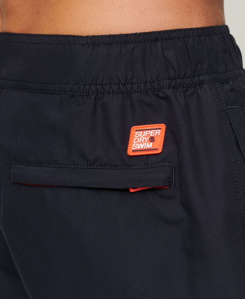 Bring that sporty edge to your look with our Classic Boardshorts. Designed to bring you an iconic look even when you're hitting the water, these swim shorts are a comfortable option. Finished with bold branding to bring the look together.Waistband with elasticated sidesHook and loop fastening waistLace tieTwin side pocketsSilicone print logo on the legBack zip pocketsMesh liningSilicone Superdry tab and patch