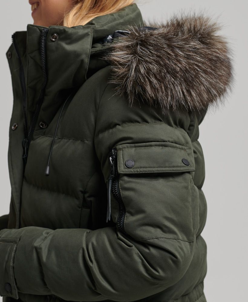 Warm up in style this winter with the Microfibre Expedition Longline Parka coat. Taking the classic parka design and making it longer and more luxurious has made this coat more distinctive, giving your winter wardrobe that added personal duvet lift. Casual, crafted and definitely functional, the Expedition longline parka will be the one you turn to.Relaxed fit – the classic Superdry fit. Not too slim, not too loose, just right. Go for your normal sizeUK10 shoulder to hem: 125cmLong-line quilted designRemovable hoodDetachable faux fur hood trimAdjustable hoodDrawstring hoodBungee cord hemTwo-way zip and popper fasteningFour-pocket designPopper cuffs with ribbed insertsTwo sleeve pocketsSignature logo badgeFully linedBungee cord waist adjusterInner mesh pocketInner zipped pocketThe padding in this jacket is 100% recycled, each jacket contains up to 30 recycled bottles, this avoids these bottles being sent to landfill or polluting our oceans.