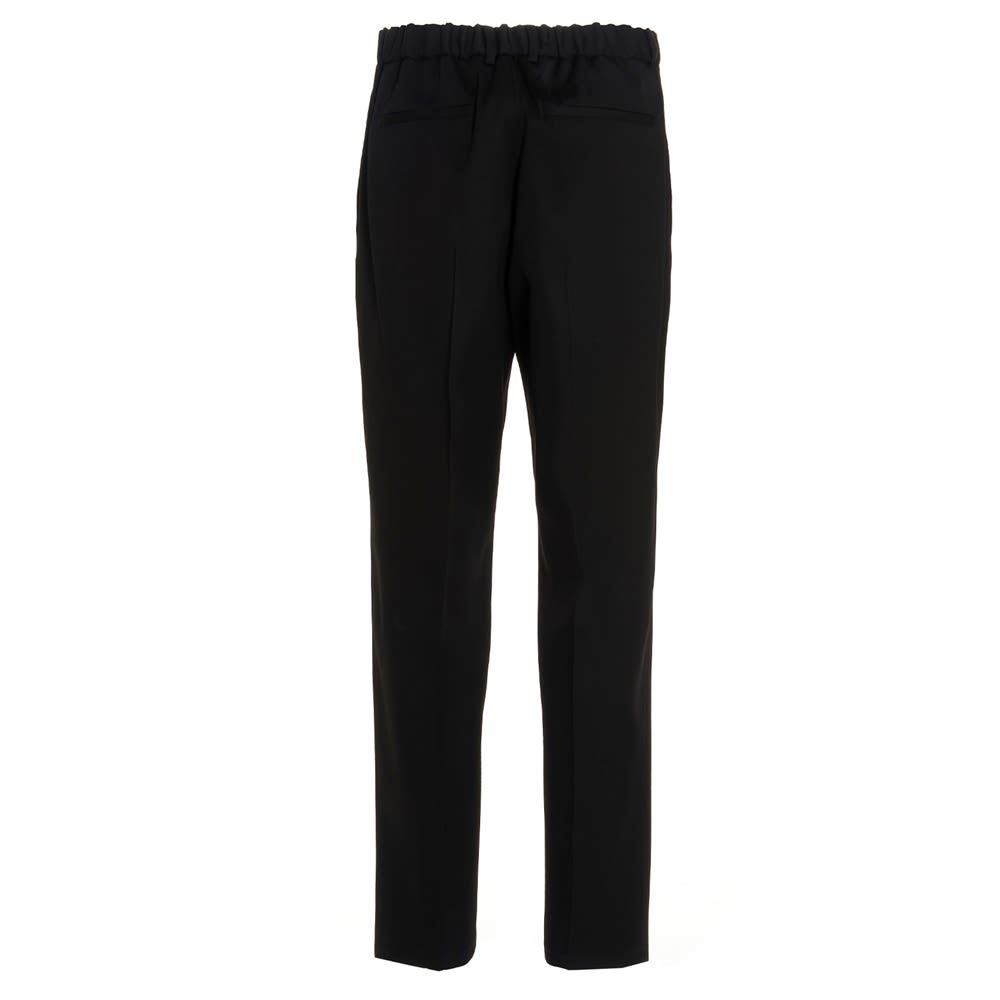 Wool trousers with a central pleat, a zip, hook-and-eye and button fastening, welt pockets, a tapered cropped leg, and a relaxed fit.