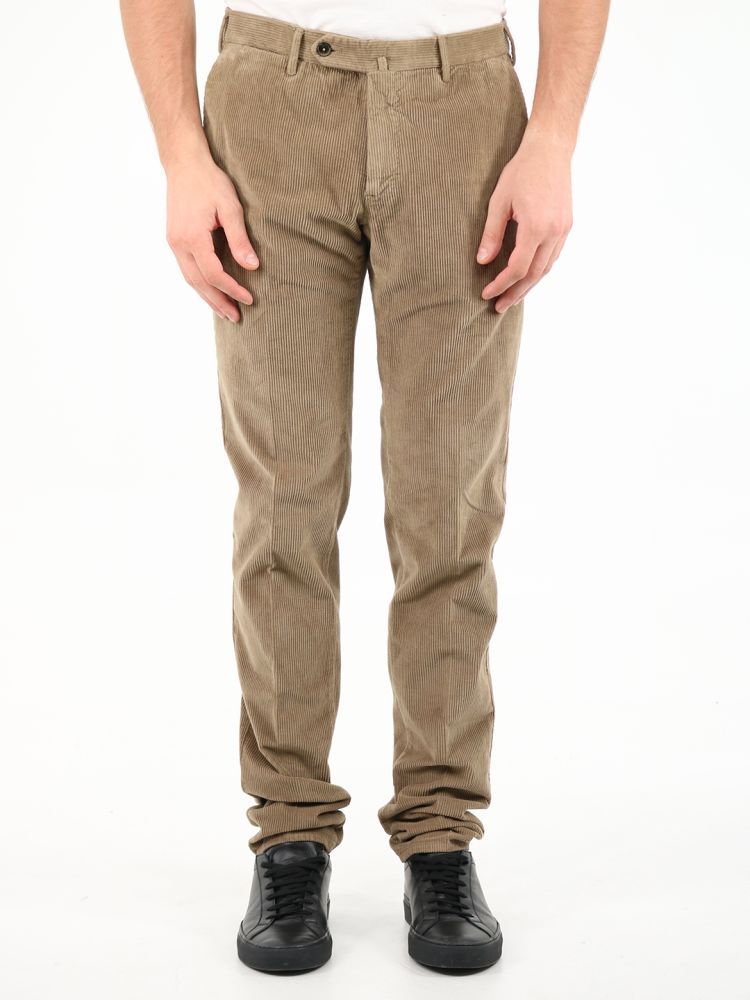 Beige corduroy trousers. They feature front zip and button closure, two side welt pockets, two back pockets with button and belt loops.The model is 184 cm tall and wears a size 48
