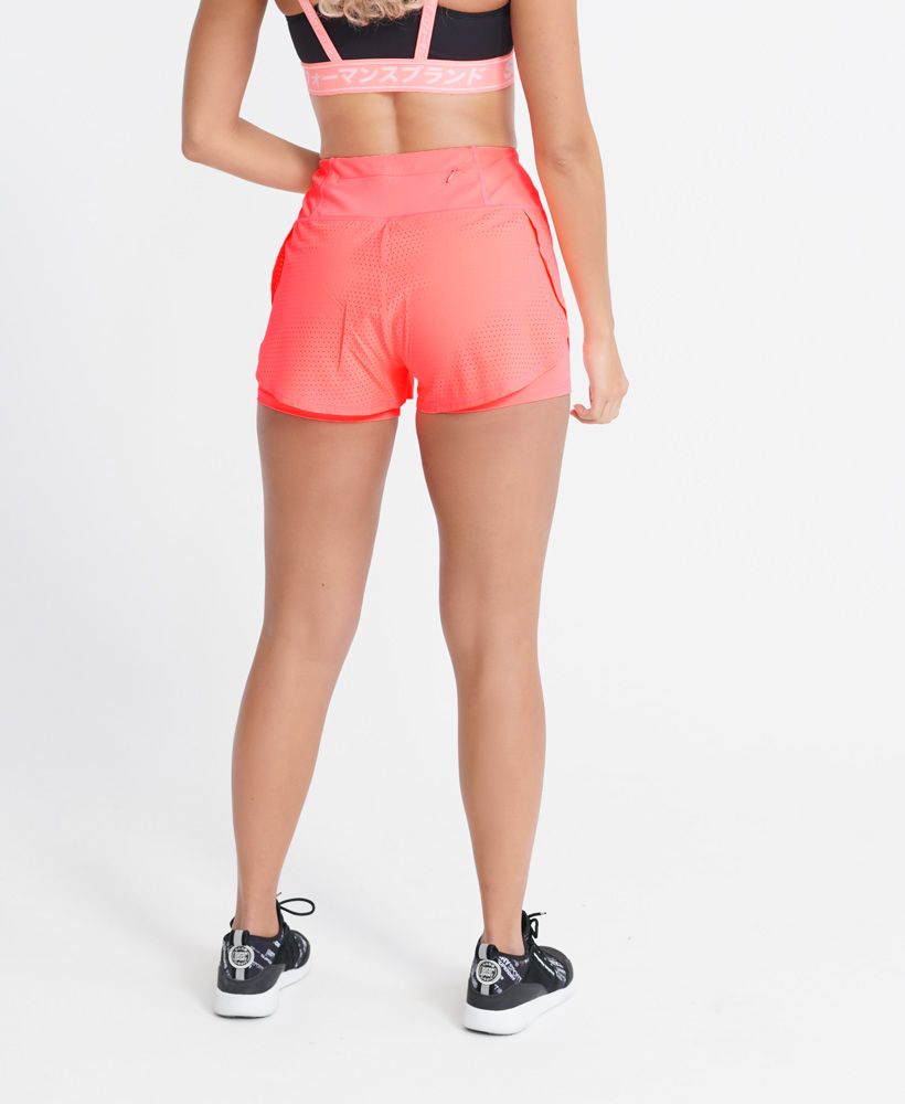 Superdry women's Training lightweight double layer shorts. These breathable and light shorts are designed to help keep you dry and cool during your work out. Featuring a stretchy bottom layer, a breathable mesh top layer, an elasticated waist, and a single pocket on the back of the waistband. Finished with a reflective Superdry sport logo on one leg of the bottom layer.