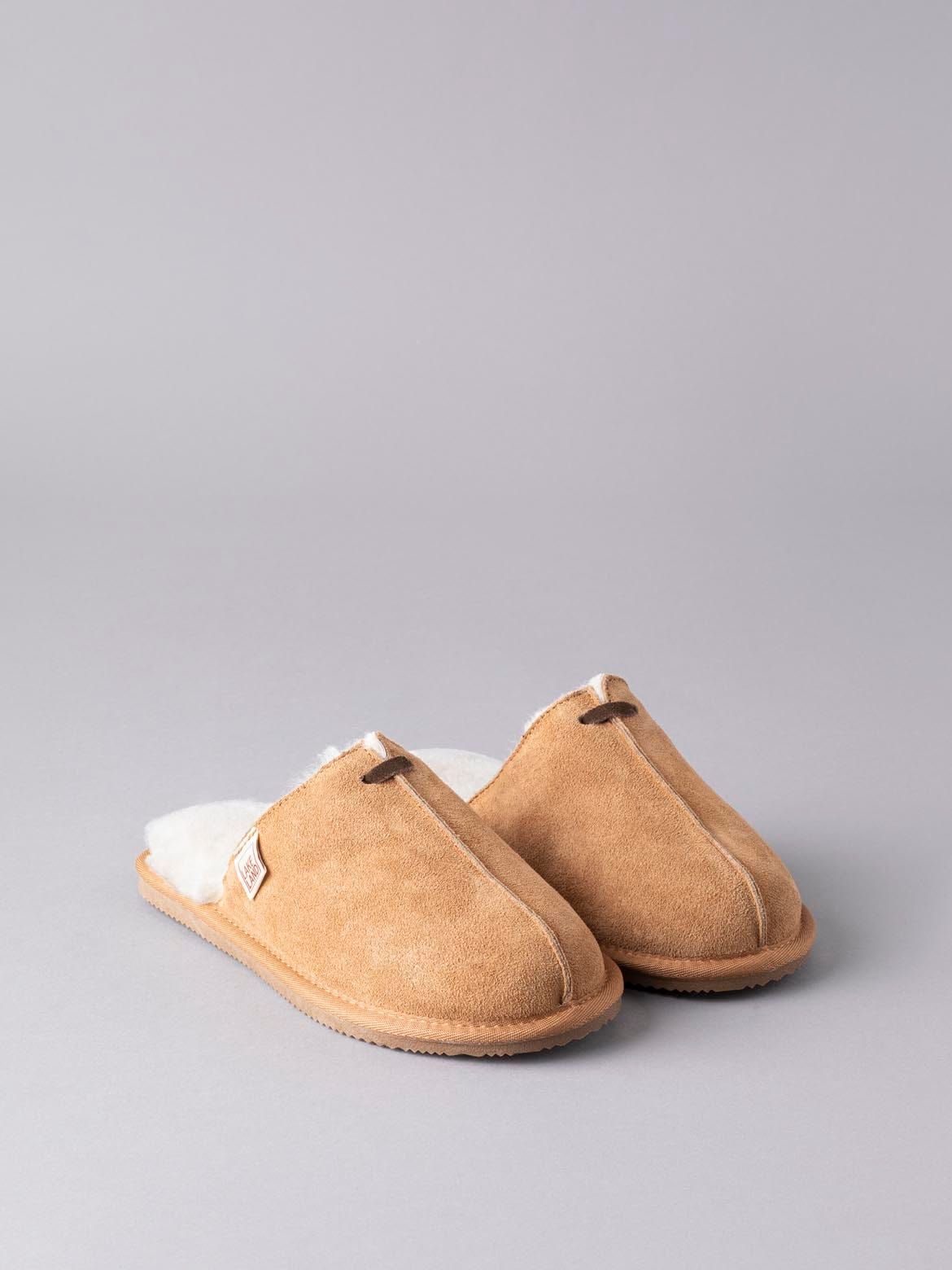 Our traditional slider slippers have had a little upgrade (well, quite a few upgrades!). Hand-crafted in sumptuously soft 100% sheepskin, the sueded, velvet-like exterior has a distinctive front seam and contrasting leather tab. Inside, they are a treat for your feet (we couldn't resist), not only is the soft wool a fabulous insulator and thermal regulator, but our new insole features air-pockets to provide the ultimate cushioned feel. The natural fluffiness of the sheepskin will make your slippers feel slightly small at first but this will soon mould comfortably to your foot. If the length feels fine, you have the right size. If you can feel your toe is touching the front of the slipper, it is too small, you'll need to size up. We recommend you size up if you are between sizes.