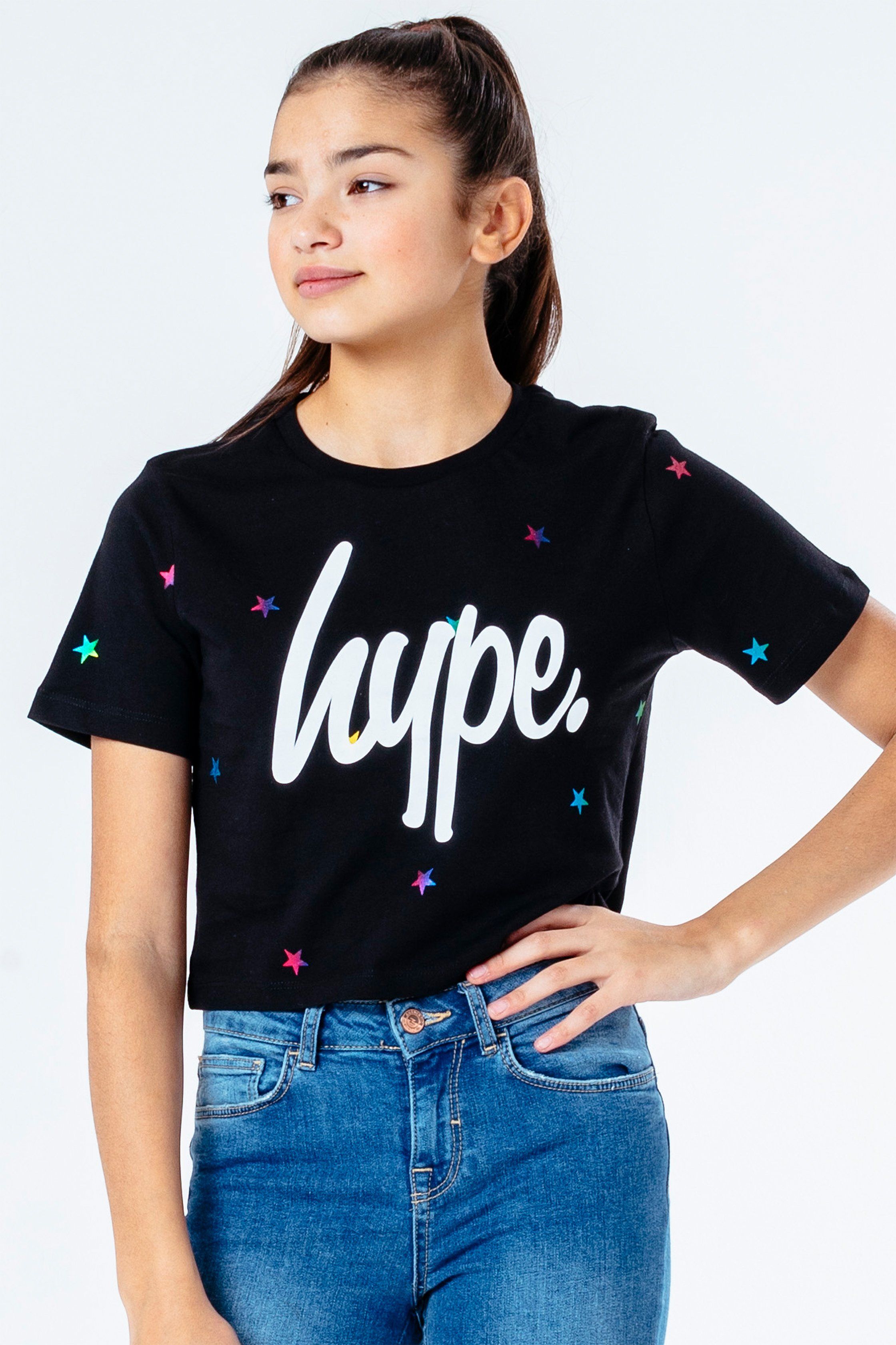 The HYPE. Magic Star Kids Crop T-Shirt is your new go-to tee. Designed in a black 100% cotton fabric base for supreme comfort in our standard crop t-shirt shape, highlighting a crew neck line and short sleeves. With an all-over star print in a rainbow transfer. Finished with the iconic HYPE. script logo in a contrasting white. Wear with the matching runner shorts to complete the look. Machine wash at 30 degrees.