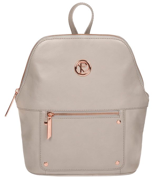 The 'Rubens' backpack from Pure Luxuries London is crafted from beautiful leather that has a luxurious finish. A unique angled zip-round top secures the central compartment, lined with 100% cotton and features two slip pockets. On the front of the bag is a spacious zipped pocket that is ideal for on-the-go storage. Furnished with rose gold-coloured fittings including the Pure Luxuries London logo and embossed charm. Comes with matching, thin leather shoulder straps which are easily adjusted.