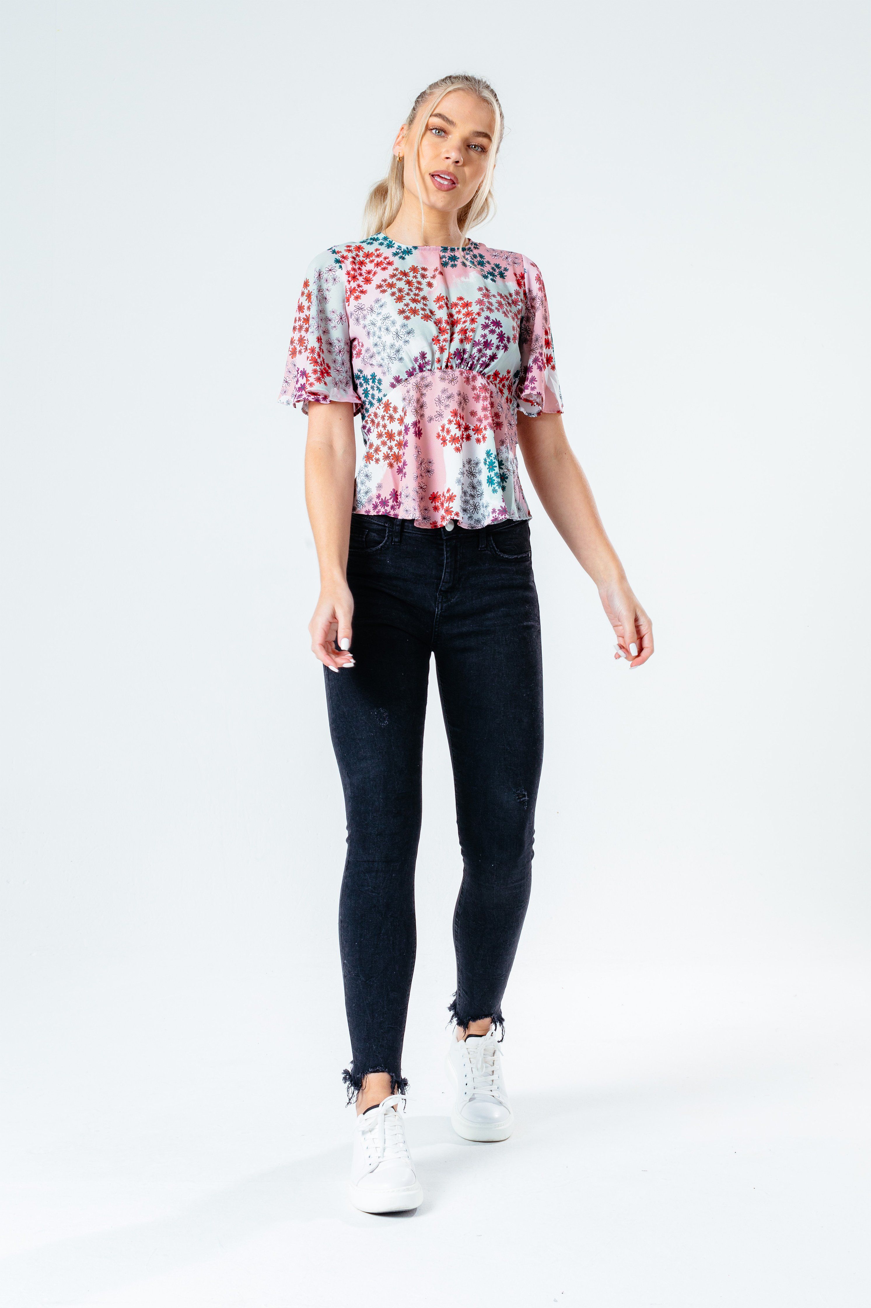 The HYPE. women's paint daisy blouse features a dusty pink, mint, purple and red colour palette. Designed in an all over floral inspired design in a poly fabric base for comfort and breathable space. In our standard women's eve blouse t-shirt shape and  short sleeves. Wear with high-waisted denim jeans for an everyday essential look. Machine washable.