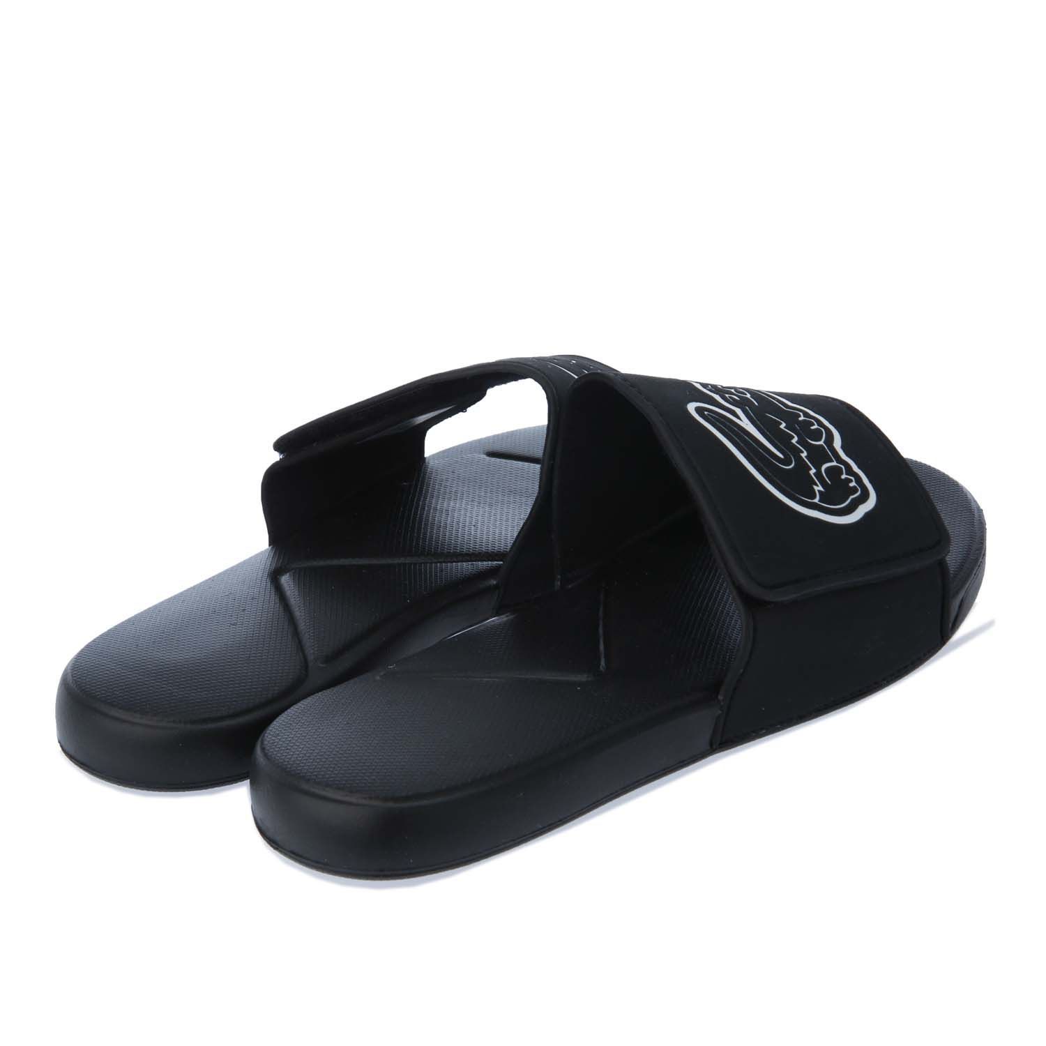 Junior Lacoste L.30 Strap Slide in black.- Synthetic uppers.- Slip on fastening.- Adjustable hook and loop strap ensures.- Oversized debossed crocodile branding on the strap.- Injection-Moulded Eva outsole.- Rubber sole.- Synthetic upper  Textile and synthetic lining  Synthetic sole.- Ref: 741CUJ0010312