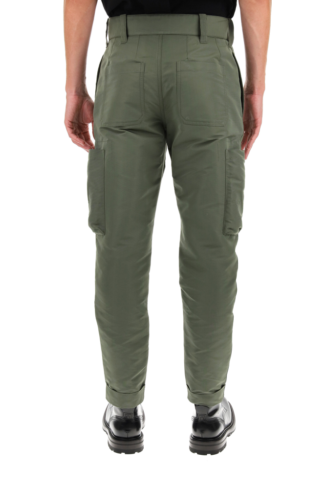Alexander McQueen baggy military trousers in sustainable polyfaille with patch pockets with horn buttons. Front closure with zip fly and button, side inseam pockets, rear patch pockets. Cuffed hems. The model is 185 cm tall and wears a size IT 46.