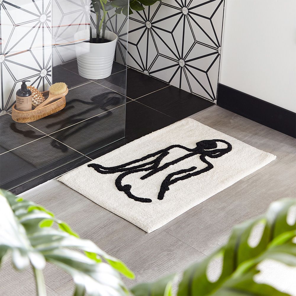 Featuring an abstract design of the female form in a stylish monochrome colour palette. Made from 100% Cotton, making this bath mat incredibly soft under foot. This bath mat has an anti-slip quality, keeping it securely in place on your bathroom floor. The 1800 GSM ensures this bath mat is super absorbent preventing post-bath or shower puddles.