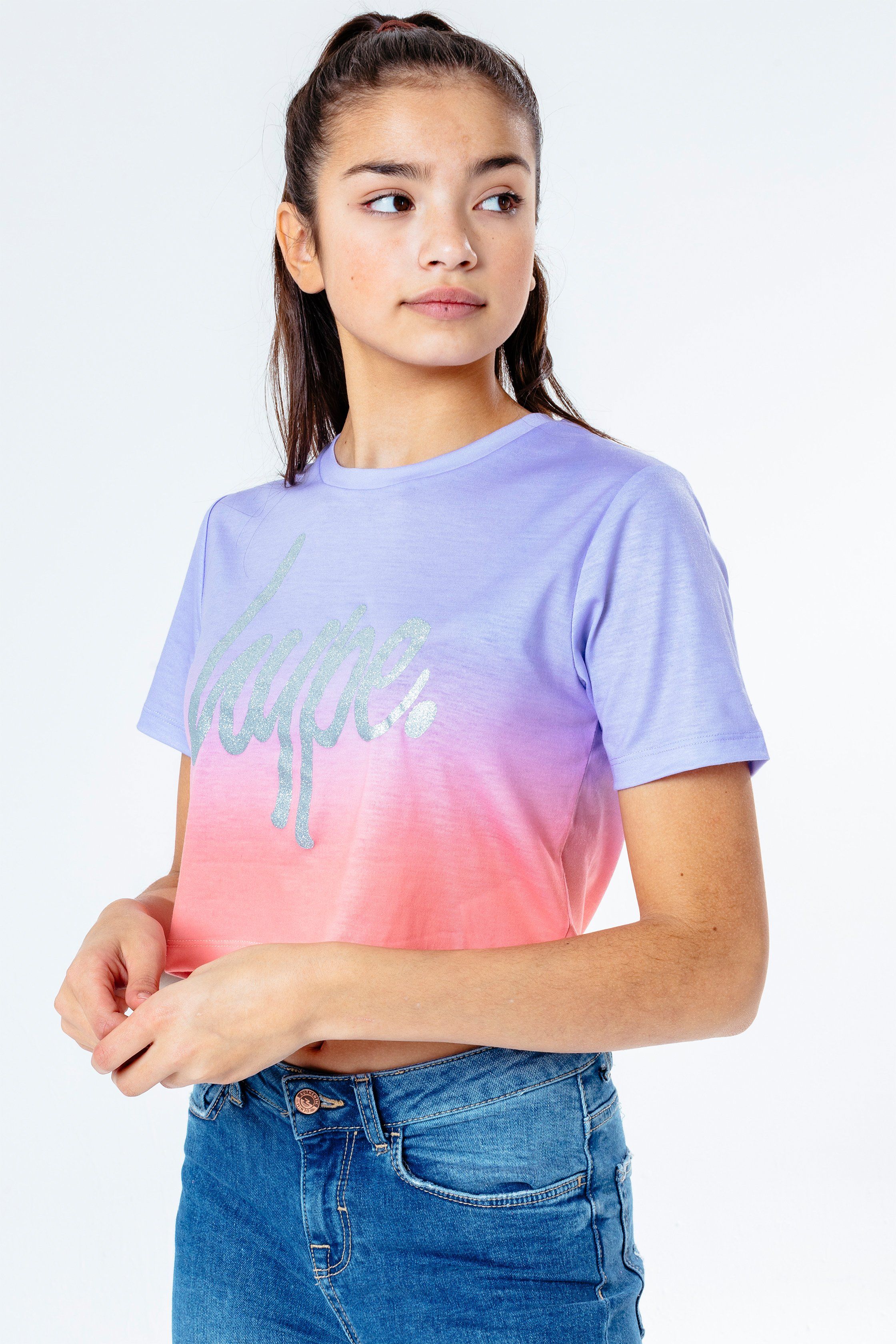 The HYPE. Peach Fade Kids Crop T-Shirt is your new go-to tee. Designed in a 95% polyester and 5% elastane fabric base for supreme comfort in our standard crop t-shirt shape, highlighting a crew neck line and short sleeves. With an all-over signature fade effect in a lilac and peach colour palette. Finished with the iconic HYPE. script logo in a contrasting silver. Wear with the matching leggings to complete the look. Machine wash at 30 degrees.