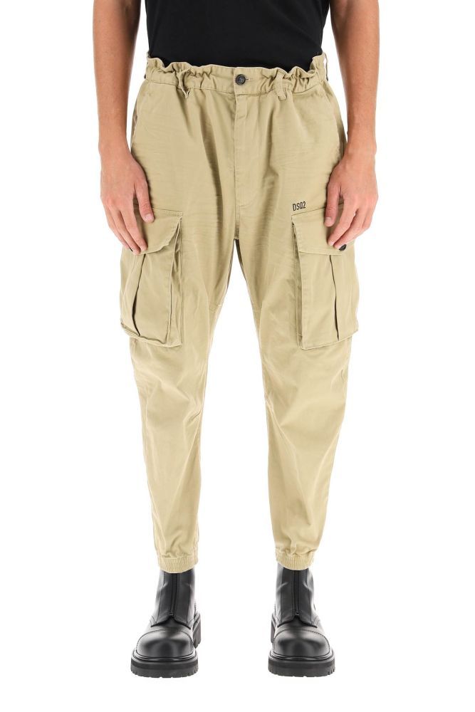 Cargo trousers in stretch gabardine by Dsquared2, enhanced by a loose cut with elastic insert at the waist and internal leather drawstring. Pockets on the sides, back and legs, zip and button closure, ankle length with elasticated cuffs. Logo detail printed at front. The model is 185 cm tall and wears a size IT 46.