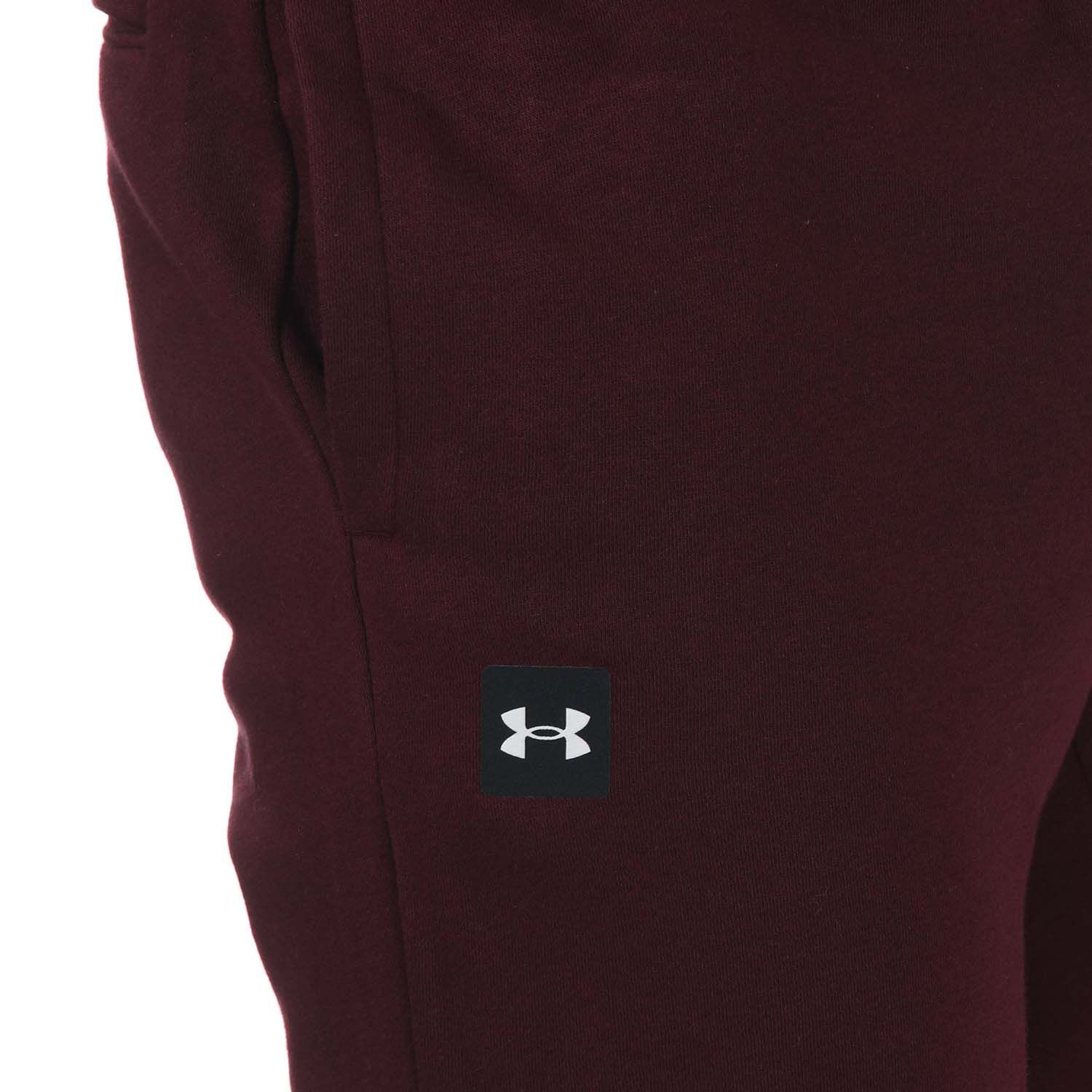 Mens Under Armour Rival Fleece Joggers in burgundy.- Encased elastic waistband with external drawcord.- Open hand pockets & secure.- Snap back pocket.- Ribbed cuffs.- Ultra-soft  mid-weight cotton-blend fleece with brushed interior for extra warmth.- Tapered leg fit- Main Material: 80% Cotton  20% Polyester. Machine washable.- Ref: 1357128600