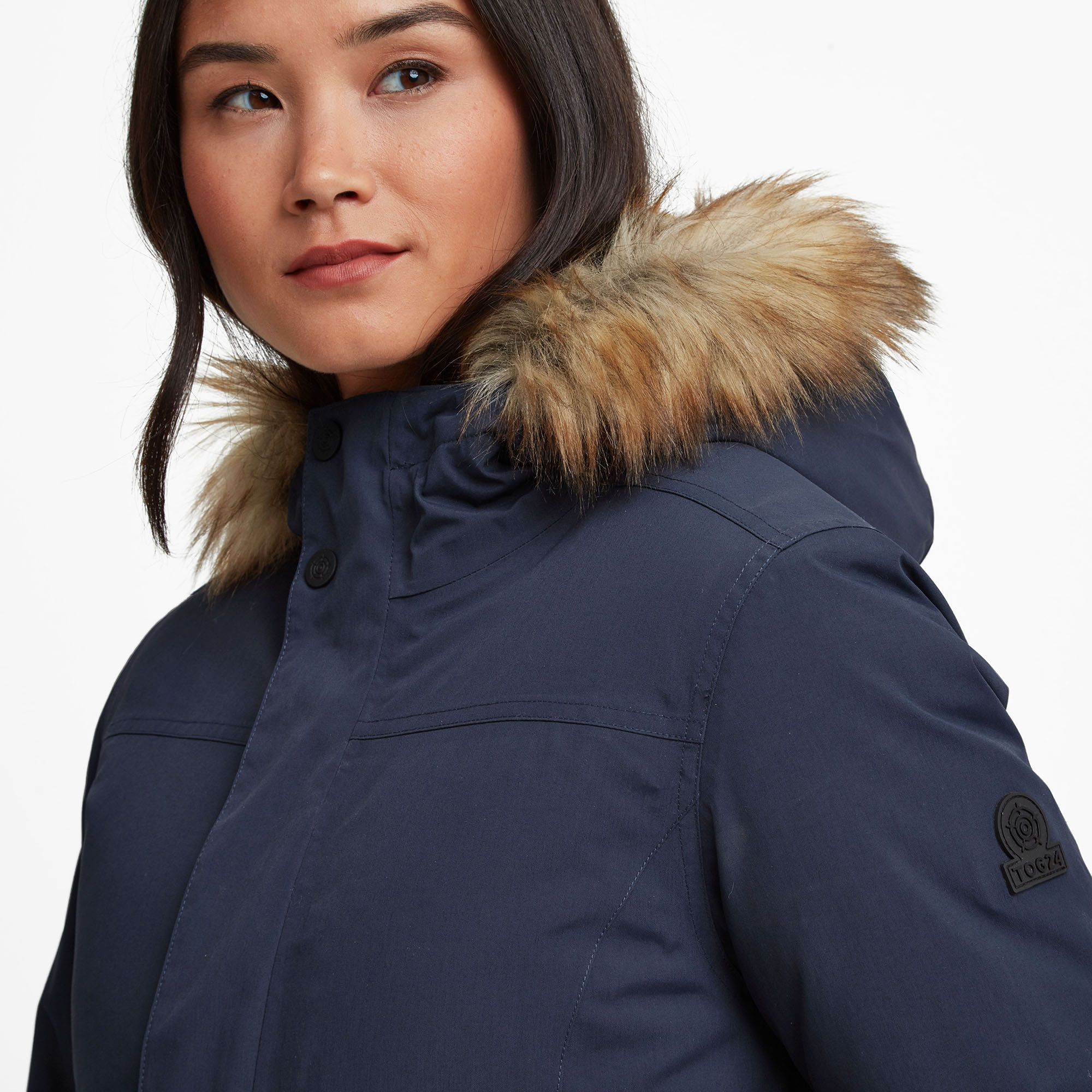 Super warm, waterproof and windproof, yet fully breathable, our Alderidge winter parka coat is timeless and cut to flatter. The hard-wearing outer layer has a smooth, matt finish that has all the good looks of casual cotton twill and an extra water repellent coating to see off showers. The taffeta lining feels silky against the skin and the insulating filling will keep you toasty warm. The cosy hood is armed with a handy Velcro adjuster and trimmed with removable and beautifully soft faux-fur, so your ears and neck are protected from the chill. Our Yorkshire-based designers have also given plenty of thought to the finer styling details, so you'll appreciate adjustable drawcords to cinch your waist in and rounded seams that give a flattering streamlined look. The full-length zip is neatly secured with press studs and Velcro and opens at both ends, so you can get air in when needed and stretch your legs when you sit down. Perfect for walks across the moors or to wear as your everyday commuter coat, you'll love the brushed fleece lined patch pockets with side entry that double as cosy handwarmers. As a final mark of quality, our embossed rubber Yorkshire Rose badge is proudly displayed on the sleeve.
