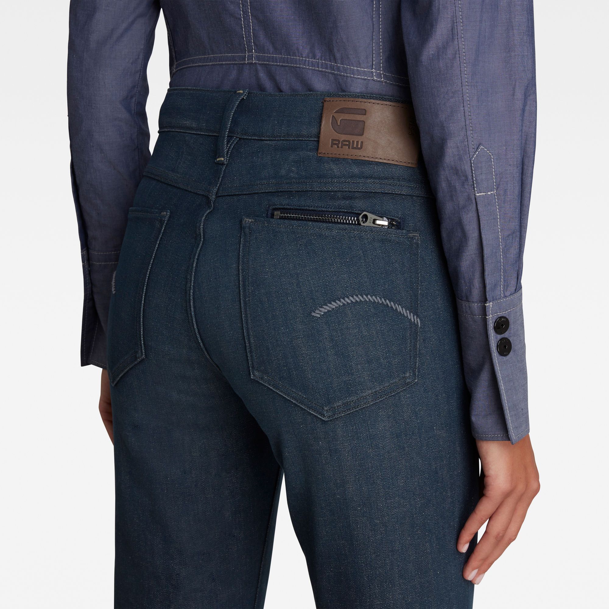 High waist. Delivered with turned up leg hem- option to unfold. Slim welt coin pocket. Back pockets with a zipper pocket inside one of them. Zip fly. Cow leather label at the back waist. Zip & button closure. Mid waist. This stretch denim is characterized by a unique dyeing shade. Indigo is combined with an industrial grey, which starts as dark grey and washes down into blue. This organic cotton fabric is enriched with a Lycra® stretch fiber to create a comfortable wear. 10.5 oz stretch denim, 3x1 right hand twill construction. Straight