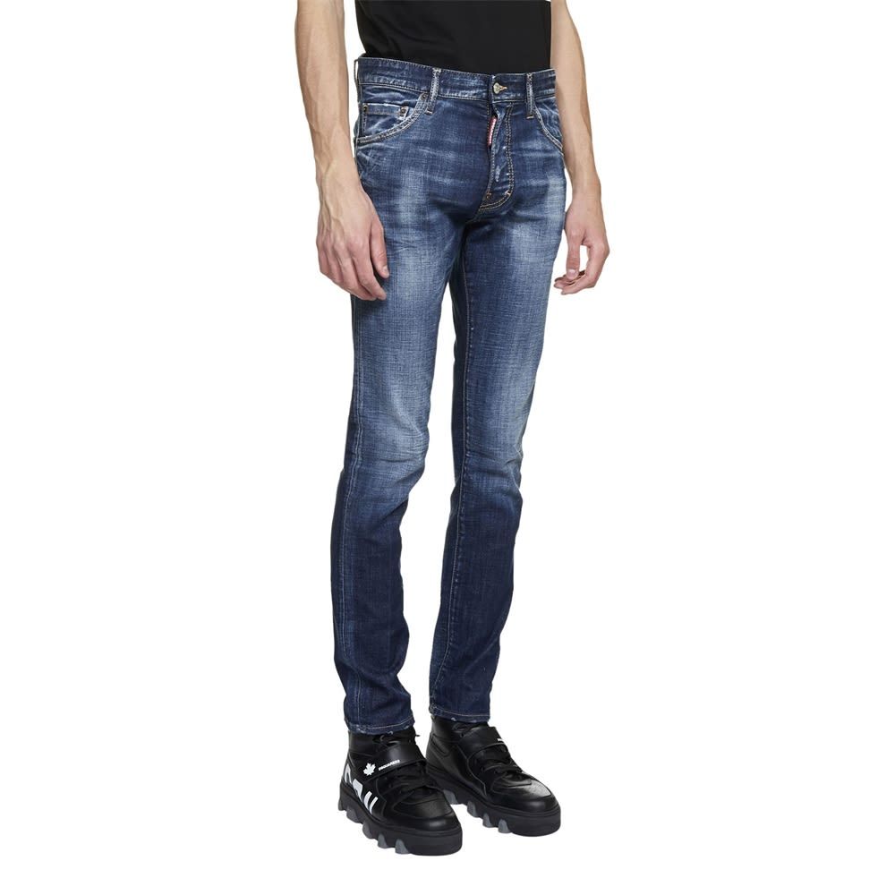 'Cool guy’ five-pocket, button-up denim jeans with a low waist, a logo patch at the back, destroyed details and a discolored effect. Long crotch, tight bottom.