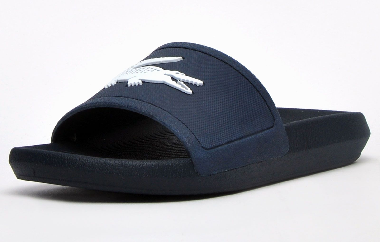 Head to the beach in style with these mens Lacoste Croco Slides. These on-trend sandals are crafted with comfort in mind whilst boasting a great water resistant super comfy footbed for a great fit and feel for the pool side and everyday wear. These designer slides are finished with eye catching Lacoste branding throughout just in case you want a sign of approval that youre wearing cool chic style this summer season
 
 - On trend synthetic upper
 - Comfort moulded footbed
 - Grippy outsole
 - Slip on wear
 - Iconic Lacoste branding throughout
 Please Note: These slides are supplied poly bagged (without box)
 These Lacoste Slides are sold as B grades which means there may be some very slight cosmetic issues on the shoe and they come in a poly bag. There could be occasional issues with wrong swing tags being allocated to wrong shoes by Lacoste themselves which could result in some size confusion but you must take the size IN THE SHOE as the size that the shoe actually is ( not what is on the tag ). We have checked most of the shoes and in our opinion,all are practically perfect without any blemishes on them at all and in essence if the shoes did not have the letter B denoted on the swing tag you would presume these were perfect shoes. All shoes are guaranteed against fair wear and tear and offer a substantial saving against the normal high street price. The overall function or performance of the shoe will not be affected by any minor cosmetic issues. B Grades are original authentic products released by the brand manufacturer with their approval at greatly reduced prices. If you are unhappy with your purchase, we will be more than happy to take the shoes back from you and issue a full refund