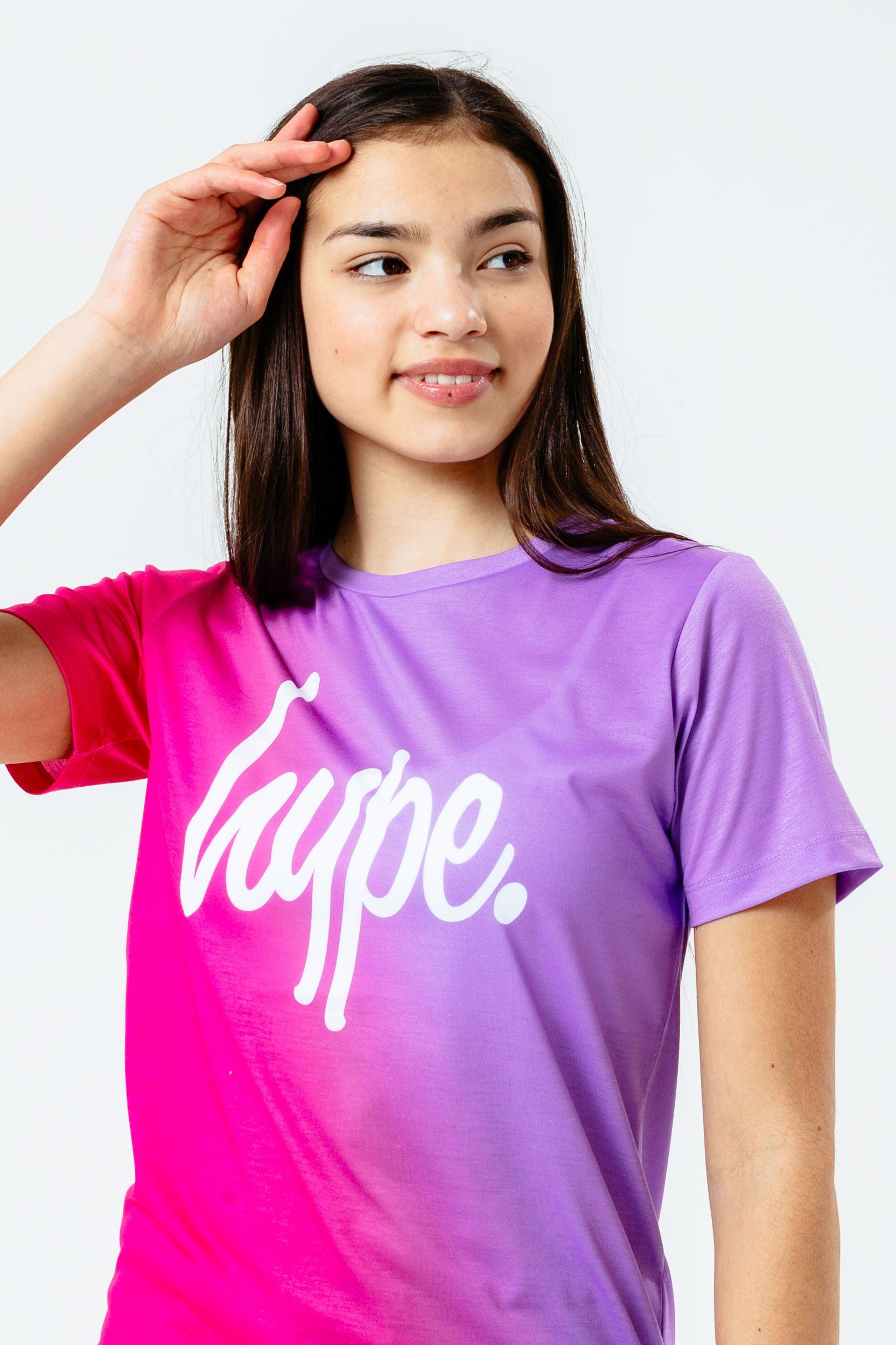The HYPE. Pink Purple Fade Kids T-shirt, your perfect go-to tee. Designed in a 95% Polyester and 5% Elastane fabric base for supreme comfort and perfect amount of breathable space. Featuring our signature fade effect in a pink and purple colour palette. Highlighting a crew neckline and short sleeves for a classic fit. Finished with the iconic HYPE. script logo in a contrasting white across the front. Wear with denim jeans, oversized jacket and trainers to complete the look. Machine washable.