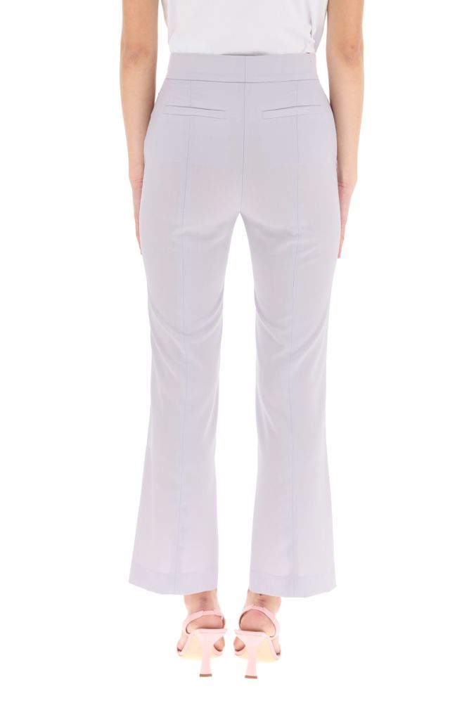 MSGM cool wool trousers with a high-waist ankle-length design, featuring front closure with button and zip fly, French side pockets, welt rear pocket. Regular fit. The model is 177 cm tall and wears a size IT 38.