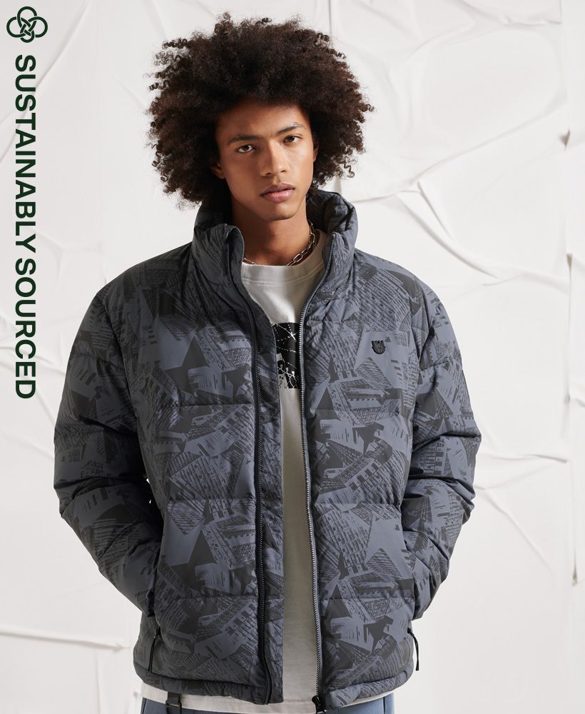 Dare to be seen in our grime inspired Surplus Reflective Down Puffer Jacket.Relaxed fit – the classic Superdry fit. Not too slim, not too loose, just right. Go for your normal size.90/10 Down fillingReflective patternMain zip fasteningTwo front zip pocketsElasticated popper cuffsD ringBungee cord hemPrinted liningOne internal pocketRubberised Superdry logo patchIconic Superdry logo tabSuperdry is certified by the Responsible Down Standard to confirm that our down filled products are sourced to ensure animal welfare.XS/S: 34
