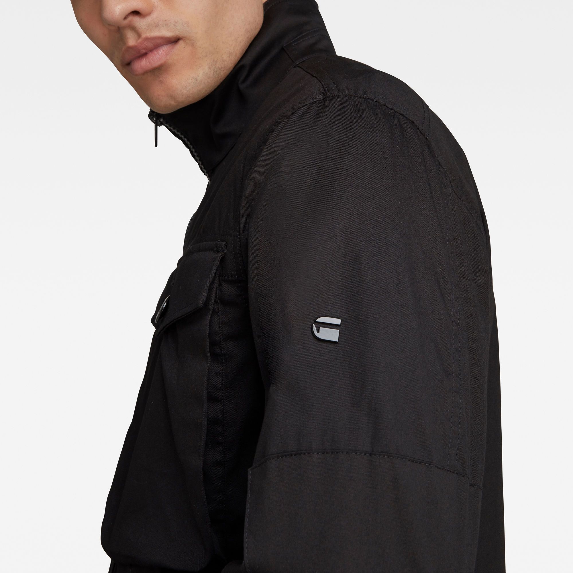 Straight fit. Standing collar. Zip and snap closures. Functional cuffs. Side seam pockets. Button front closure, Velcro closure at the top. Zip closure. The Type C Zip Utility Overshirt is crafted from longwearing twill fabric with a crisp look. With broad bellow pockets and a long fit, this functional shirt is a fresh take on a workwear staple. A contrast zip-closure adds extra interest to the front. While the straight fit gives a strong, contemporary silhouette. Reinforced elbows deliver strength where you need it. Fine twill lines