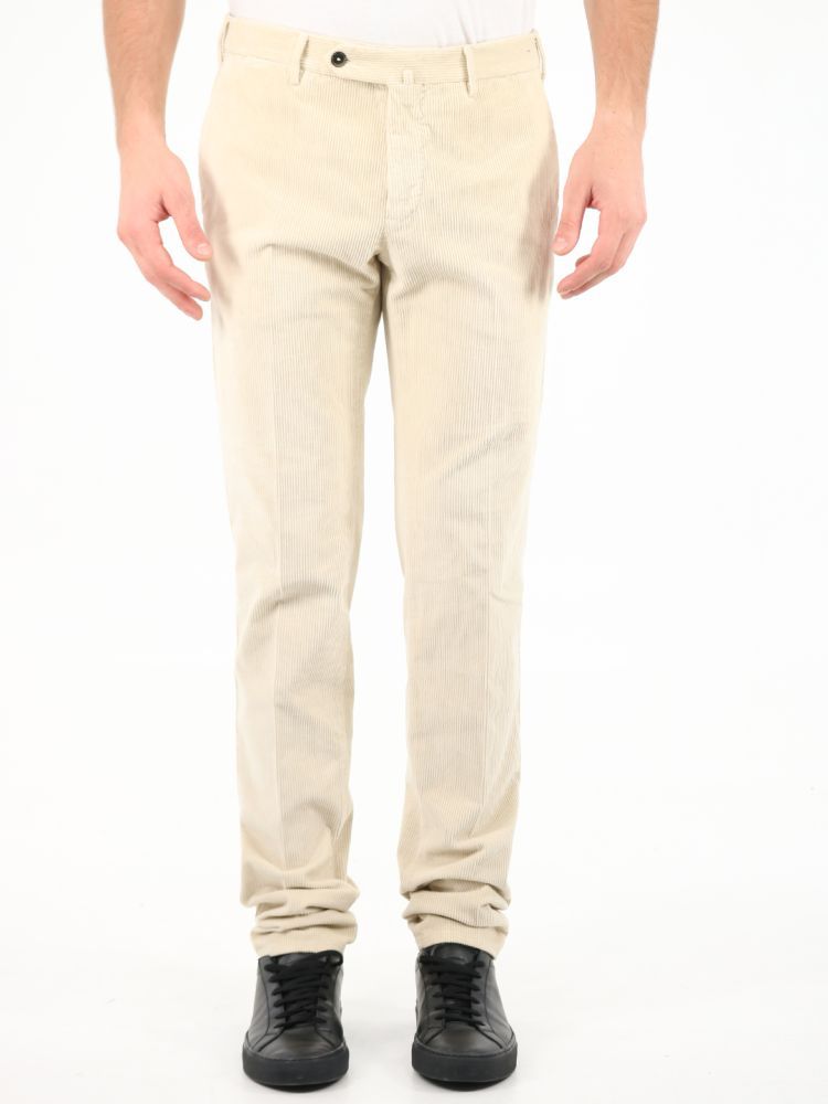 Cream-colored corduroy trousers. They feature front zip and button closure, two side welt pockets, two back pockets with button and belt loops.The model is 184 cm tall and wears a size 48