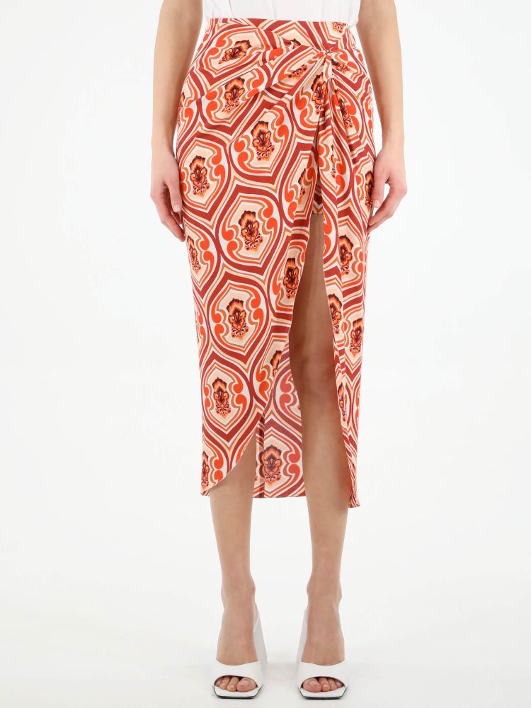 Sarong skirt with all-over orange graphic print. It features front draping and rear zip and metal hook fastening. The model is 178cm tall and wears size 40.