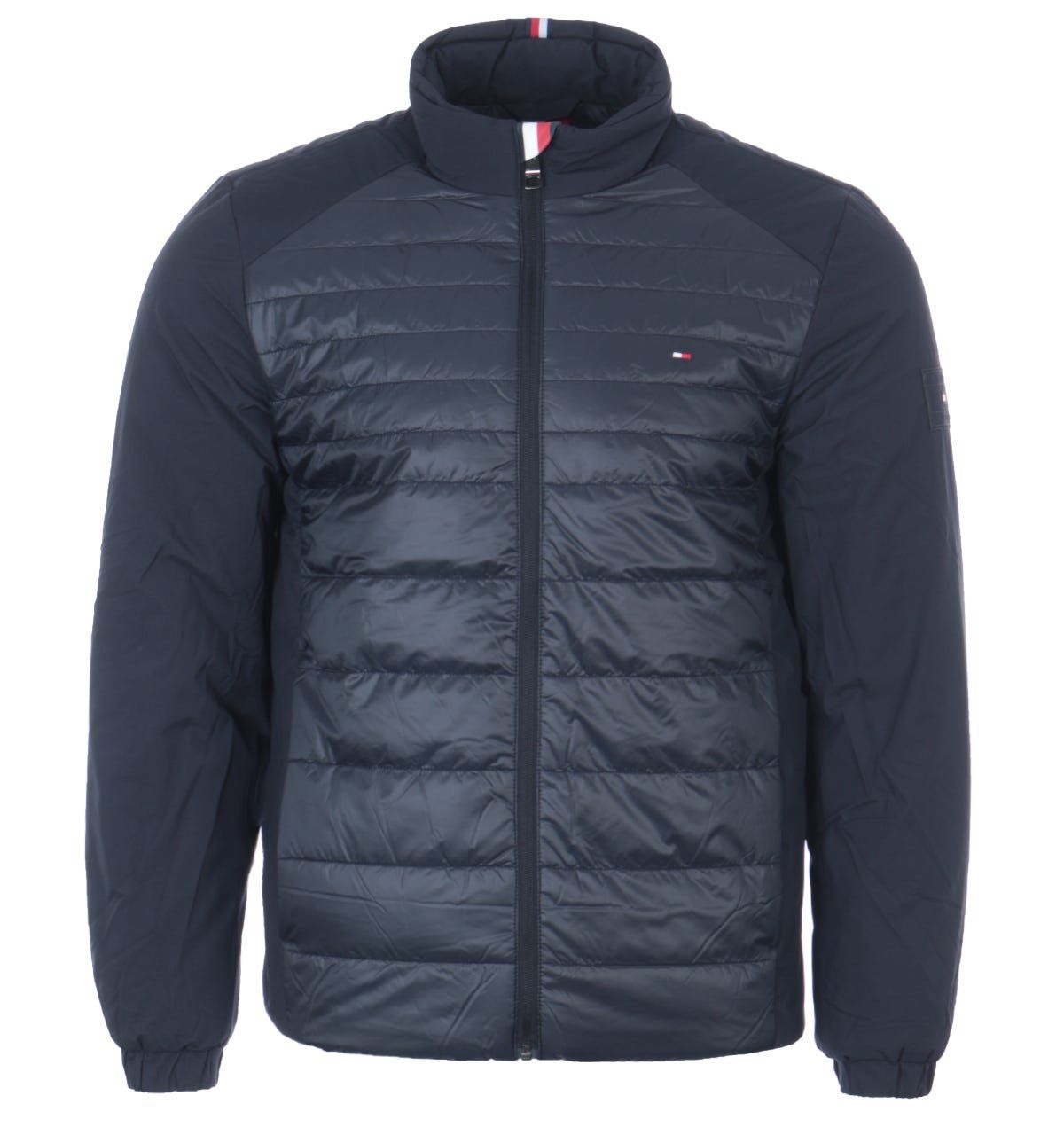 Designed with sustainability and supreme warmth in mind. This lightweight jacket from Tommy Hilfiger is the ideal piece to refresh your outerwear this season. Crafted from recycled polyester using advanced warming technology. Featuring a high neck with a full zip closure, zip chest pocket, snap button front pockets, elasticated cuffs and a quilted front. Finished with the iconic Tommy flag embroidered at the chest and signature stripe detail at the collar. Regular Fit, Recycled Polyester, Warming Technology, High Neck with Full Zip Closure, Quilted Padded Front, Zip Chest Pocket, Twin Front Snap Button Pockets, Elasticated Cuffs, Tommy Hilfiger Branding. Style & Fit:Regular Fit, Fits True to Size. Composition & Care:100% Recycled Polyester, Machine Wash.