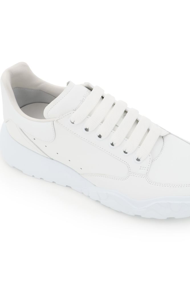 New Court leather sneakers by Alexander McQueen featuring an oversized rubber sole with an animalier motif in relief on the front and on the bottom. Painted metal eyelets, silver-tone logo print on the tongue and back, side perforations, leather interior with removable insole. Extra laces included.