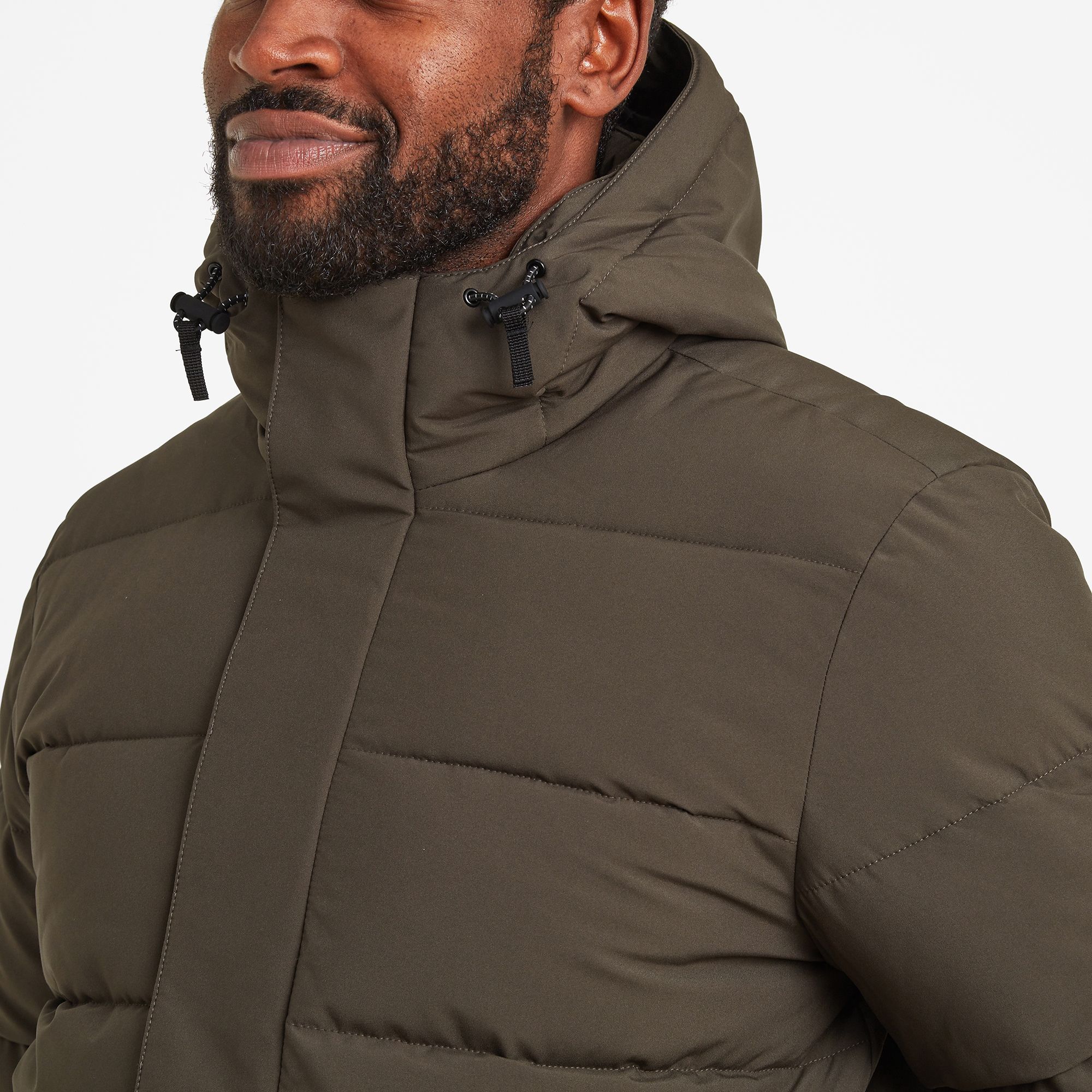 Robust and expertly designed to stand up to chilly Yorkshire winters, our chunky Askham padded jacket is perfect for days when you need to bundle up against the cold. The high performing, hard wearing outer fabric and insulated quilted body and sleeves keeps you incredibly warm and the cosy high neck and fixed, fully adjustable hood provides extra protection against the biting wind. A concealed front zip with press studs and easy Velcro fastening tab give a streamlined finish and a handy inside zip pocket, along with two outside zip pockets with chunky, wide openings, are perfect for securely carrying your wallet, phone and keys. Askham is finished with a silky taffeta lining, making it easy to slip on and off, and an embossed rubber Yorkshire Rose badge on the sleeve, heralding our Truth over Glory ethos.