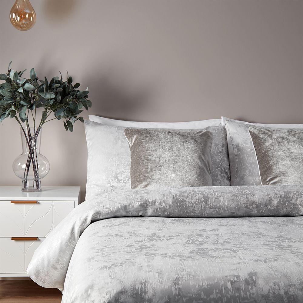 Featuring a subtle metallic jacquard design with a matching reverse. Made of a 100% Jacquard Polyester, reverse is a crisp polycotton making this duvet set is soft and hard-wearing. Clear button closure for easy removal of duvet. Includes two matching pillowcases measuring 50 x 75cm (20