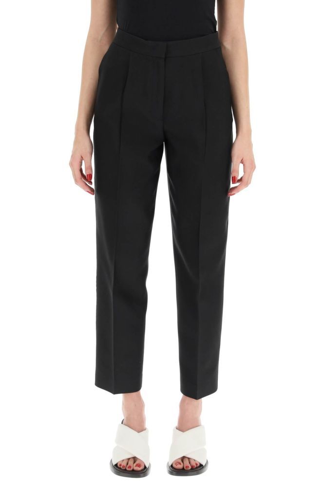 Jil Sander tailored trousers crafted in silk-blend gabardine with straight-leg cut and ankle-length. Concealed zip and hook closure, middle pleat, side inseam pockets and rear welt pockets. The model is 177 cm tall and wears a size DE 34.