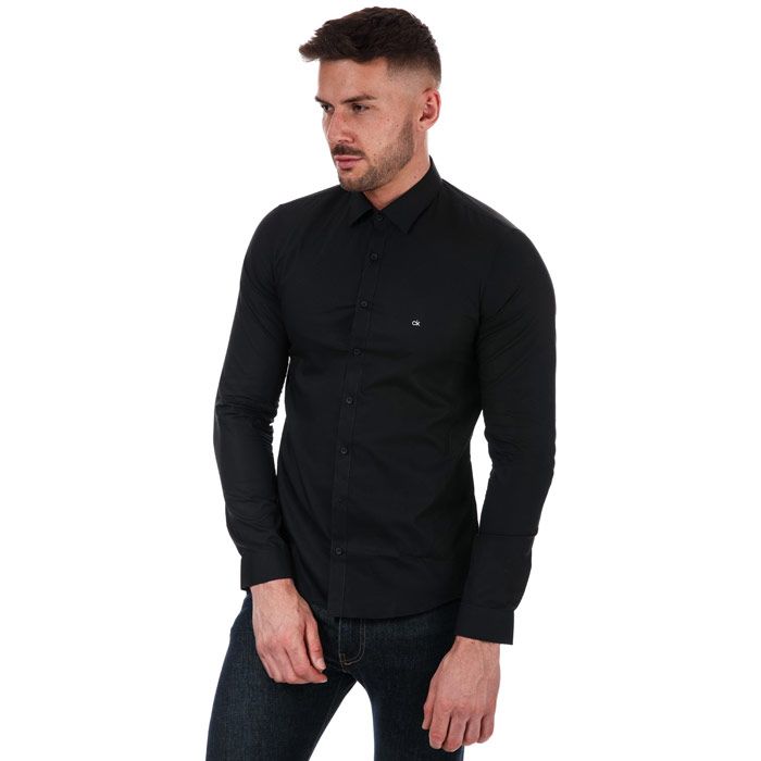 Mens Calvin Klein Extra Slim Poplin Stretch Shirt in black.- Classic collar.- Full button placket.- Long sleeves with triple button cuffs.- Rounded hem.- Embroidered Calvin Klein monogram logo at left chest.- Extra slim fit.- Soft stretch cotton poplin construction.- 98% Cotton  2% Elastane. Machine washable.- Ref: K10K1057640GN