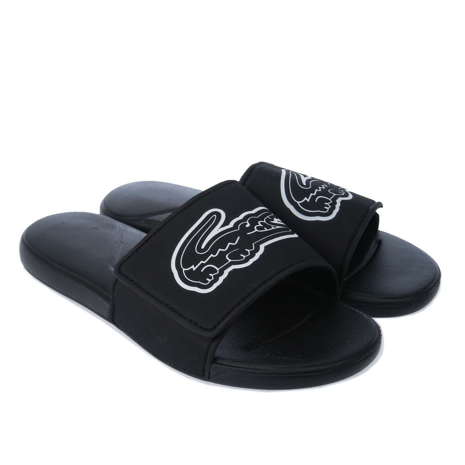 Junior Lacoste L.30 Strap Slide in black.- Synthetic uppers.- Slip on fastening.- Adjustable hook and loop strap ensures.- Oversized debossed crocodile branding on the strap.- Injection-Moulded Eva outsole.- Rubber sole.- Synthetic upper  Textile and synthetic lining  Synthetic sole.- Ref: 741CUJ0010312