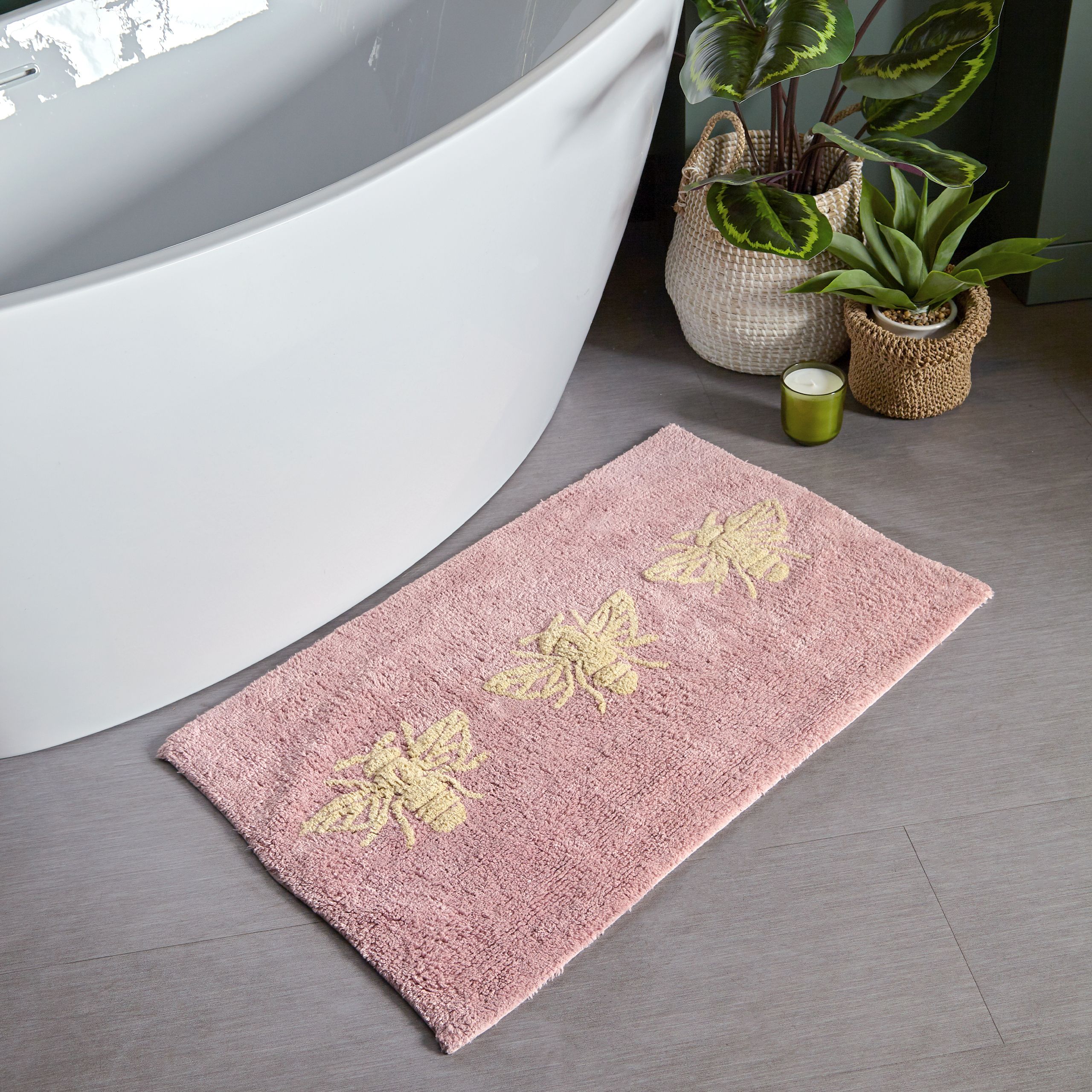 Featuring a tufted Bumblebee design on a blush pink cotton fabric. Made from 100% Cotton, making this bath mat incredibly soft under foot. This bath mat has an anti-slip quality, keeping it securely in place on your bathroom floor. The 1800 GSM ensures this bath mat is super absorbent preventing post-bath or shower puddles.