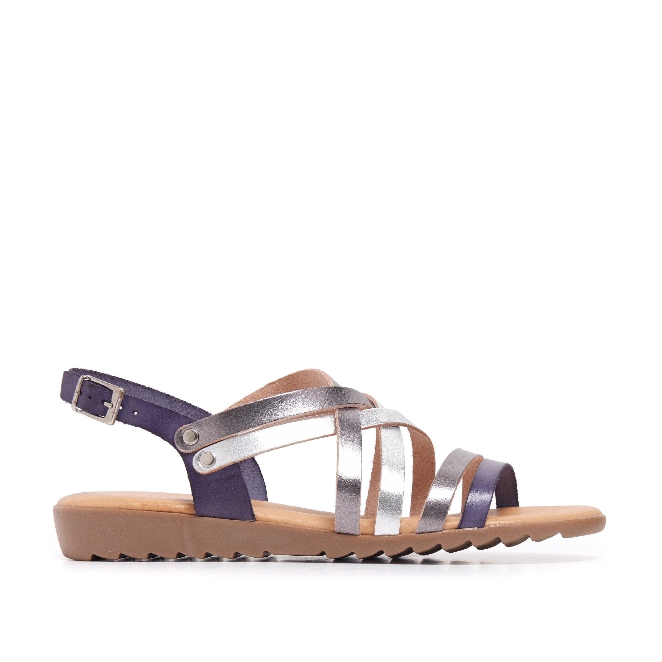 Flat leather sandal with four crossed strips and 2 strips in front. Closure: metal buckle. Upper, inner an insole : leather. Sole: Non-skid TR caramel color. MADE IN SPAIN.