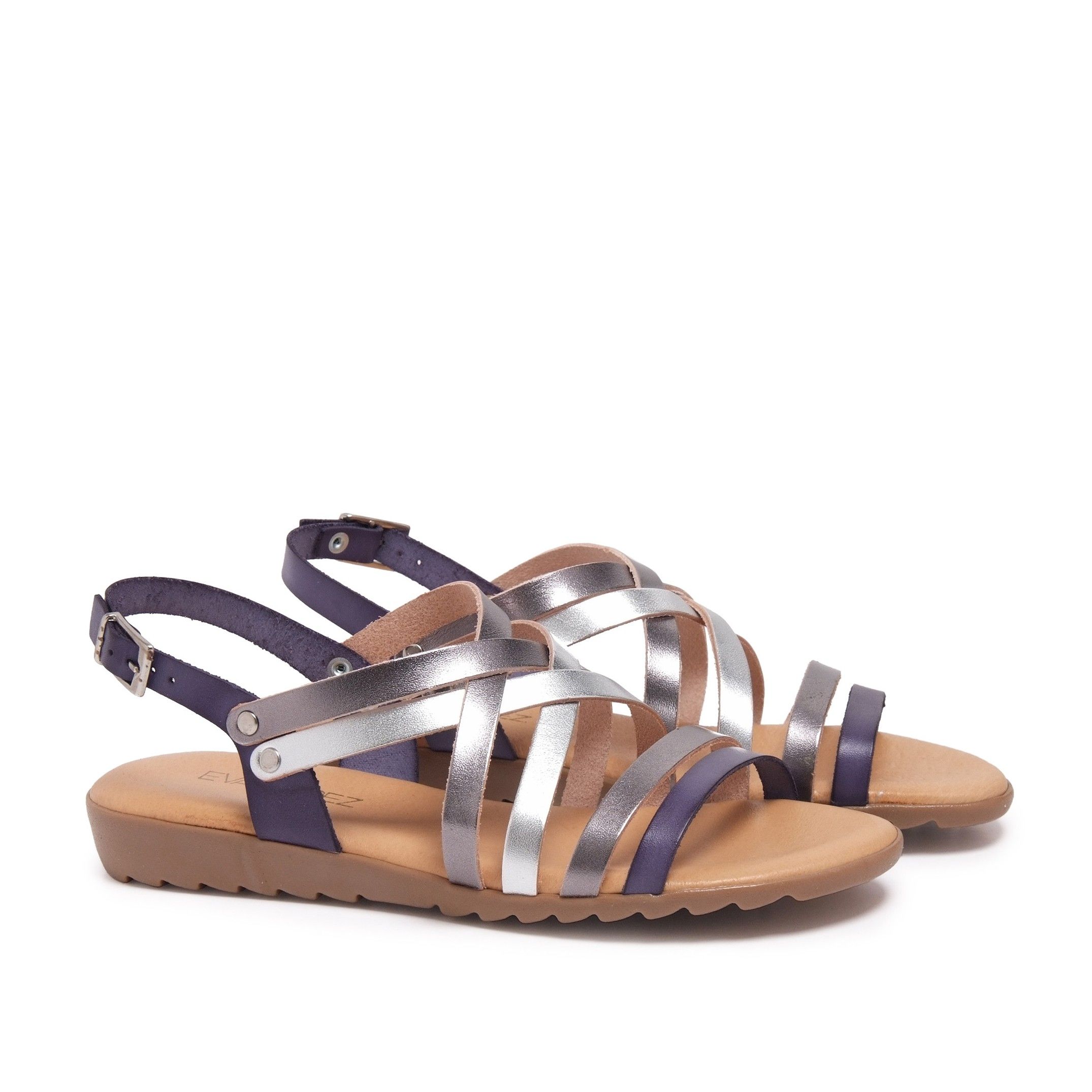 Flat leather sandal with four crossed strips and 2 strips in front. Closure: metal buckle. Upper, inner an insole : leather. Sole: Non-skid TR caramel color. MADE IN SPAIN.