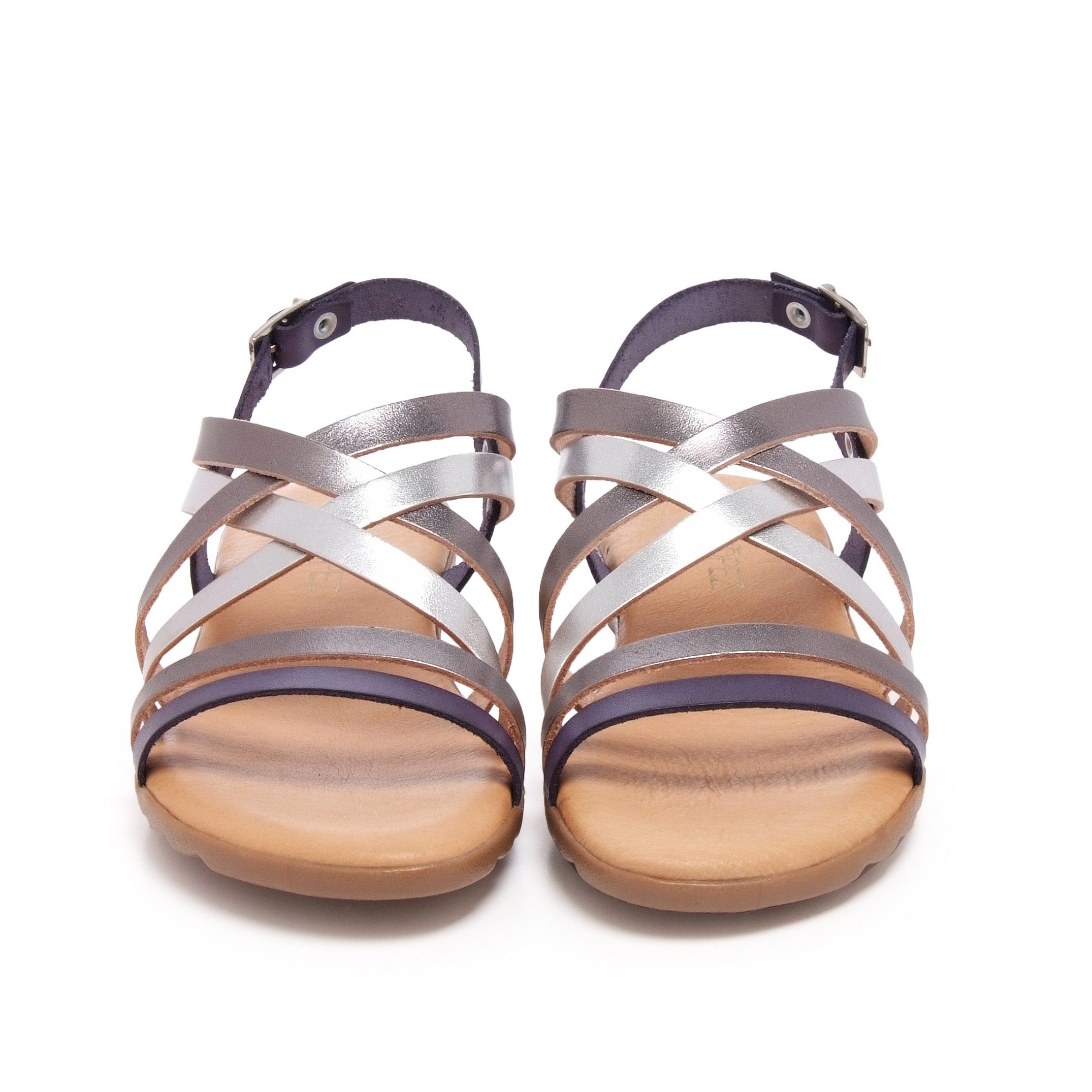Flat leather sandal with four crossed strips and 2 strips in front. Closure: metal buckle. Upper, inner an insole : leather. Sole: Non-skid TR caramel color. MADE IN SPAIN.