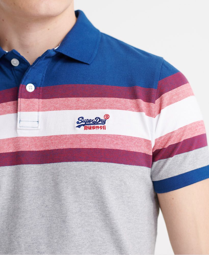 Superdry men's Malibu stripe polo shirt. Made with super soft Organic Cotton, this shirt features a single collar with button fastenings, a drop back hem with side splits and a stripe design across the chest. Finished with ribbed cuffs, an embroidered Superdry logo on the chest and a Superdry logo tab on one side seam.Slim fit – designed to fit closer to the body for a more tailored lookMade with Organic Cotton - Made using cotton grown using organic farming methods which minimise water usage and eliminate pesticides, maximising soil health and farmer livelihoods.