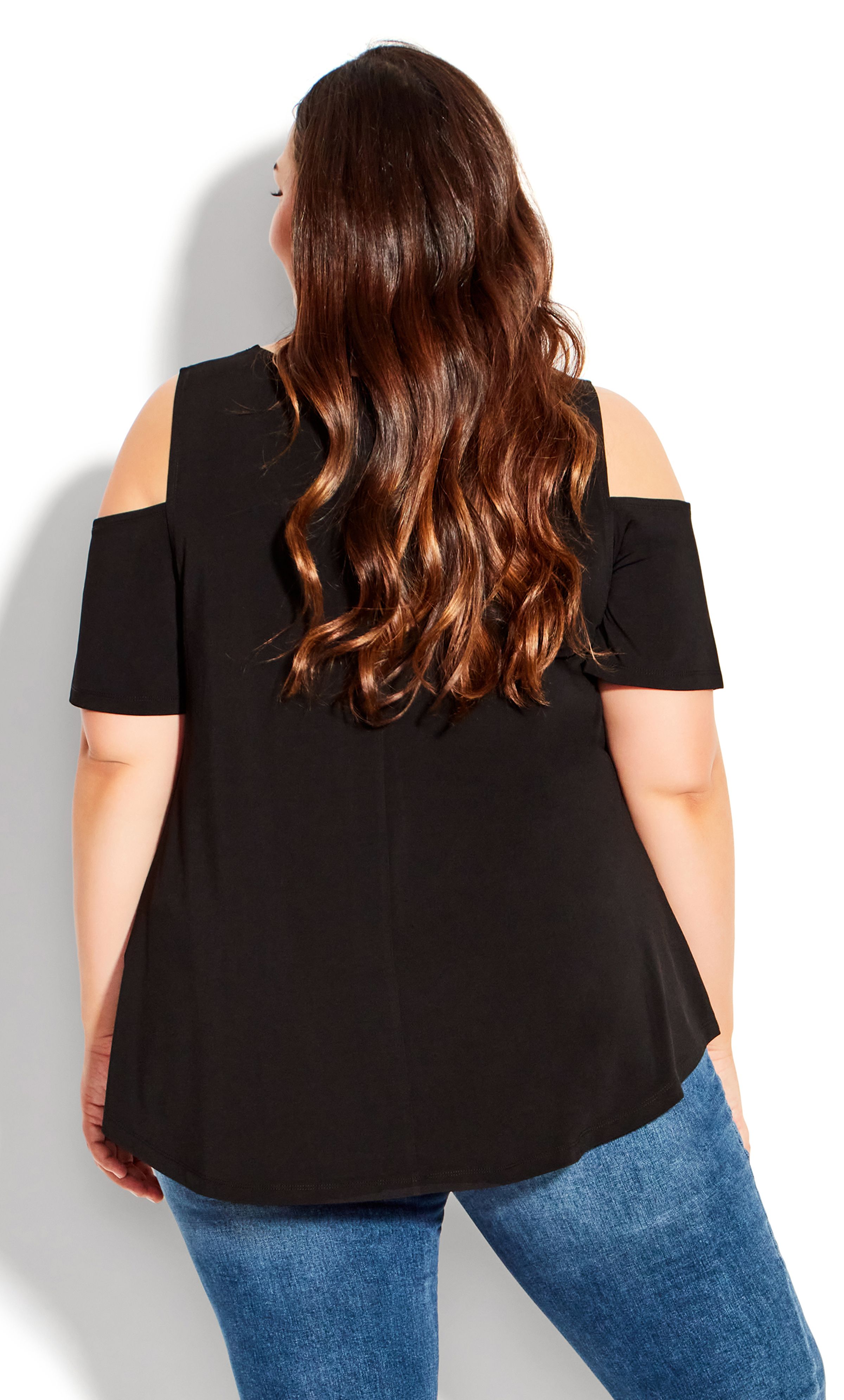 No matter where you're going, you'll be dressed to perfection in the Cold Shoulder Plain Top. This relaxed style adds a playful touch with a glimpse of shoulder and a soft stretch fabrication. A versatile black design, this top is ideal to dress up or down. Key Features Include: - Scoop neckline - Short cold shoulder sleeves - Pullover style - Darted bust for shape - Relaxed fit - Stretch fabrication - Hip length hi-lo hemline Dress up this classic top with a black skirt and a longline statement necklace.