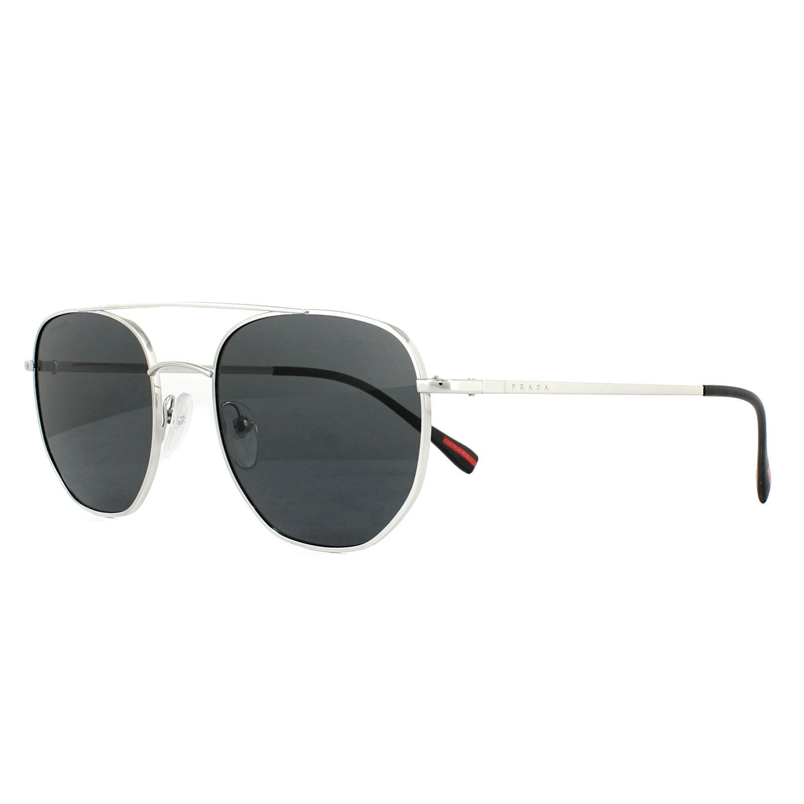 Prada Sport Sunglasses PS56SS 1BC5S0 Silver Grey are an angular frame with a round shape that has been flattened around the rims, and a prominent long top brow bar. The metal is very lightweight and rubberised nose pads further add to the comfortable feel.
