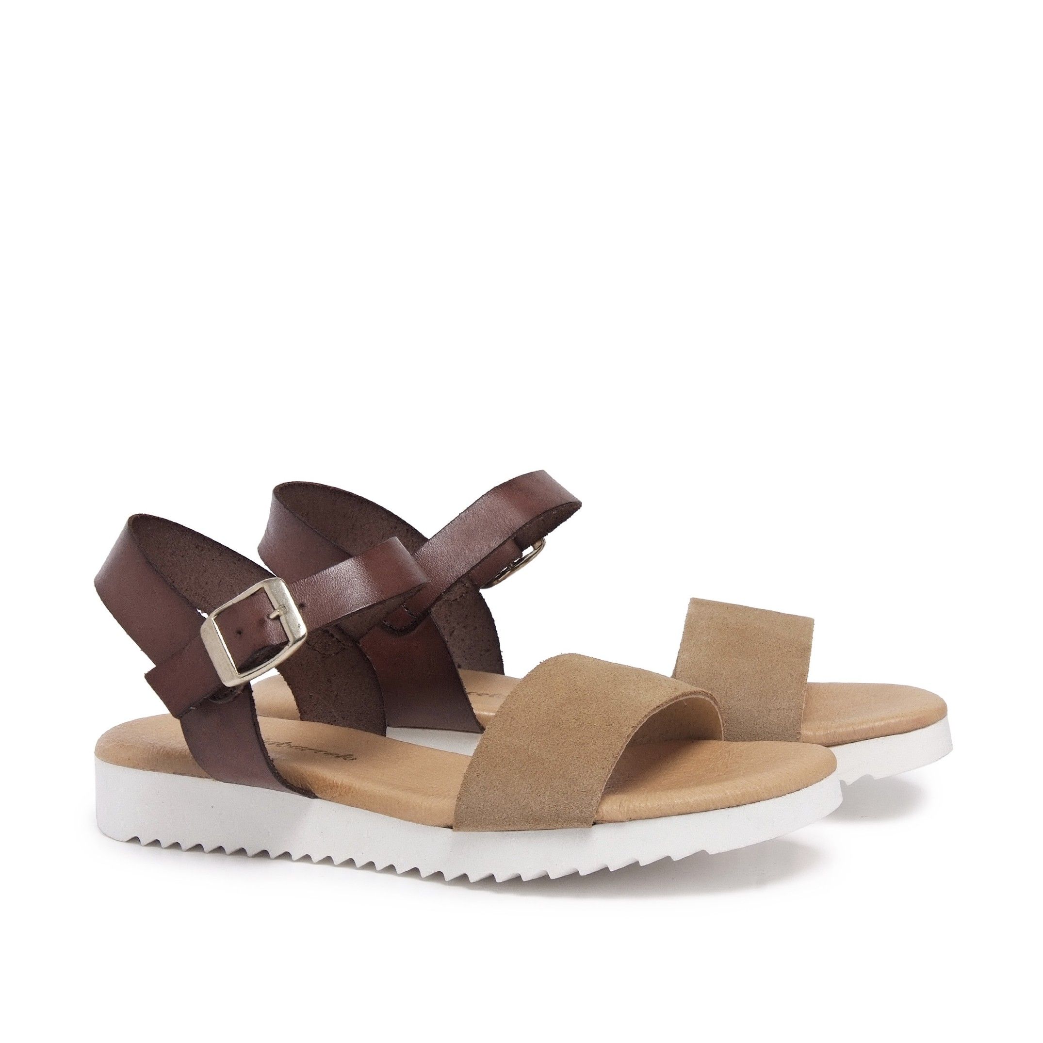 Leather flat sandal with two wide strips. Closure: adjustable metal buckle. Upper: lether. Inner: tissue. Insole: leather. Wedge: 2,5 cm. Platform: 1 cm. Sole: Non-skid TR. MADE IN SPAIN.